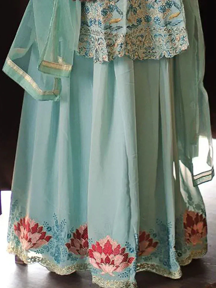 Pastel blue ethnic lehenga with floral embroidery and golden trim, traditional Indian attire