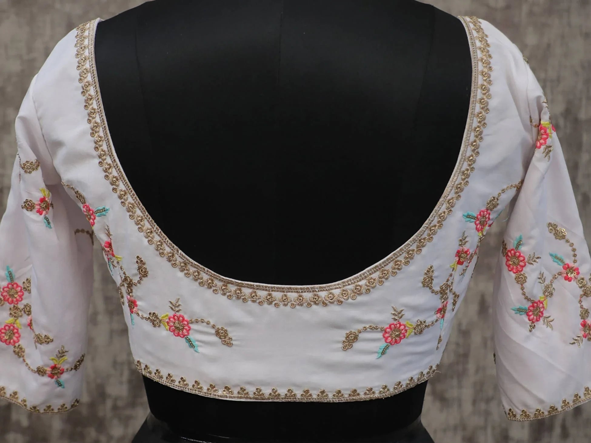 White embroidered blouse with floral gold detailing, perfect for lehenga choli or saree