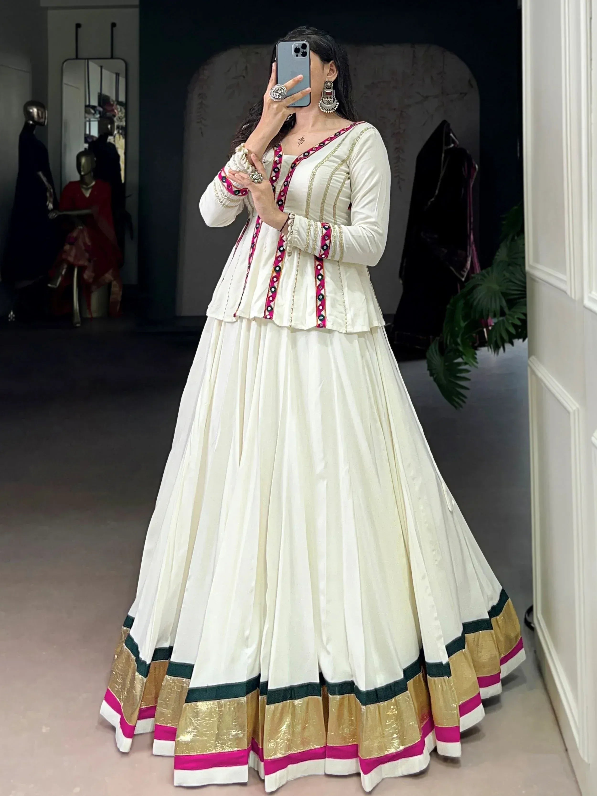 Elegant white ethnic gown with pink and gold trim, perfect for Indian festive occasions