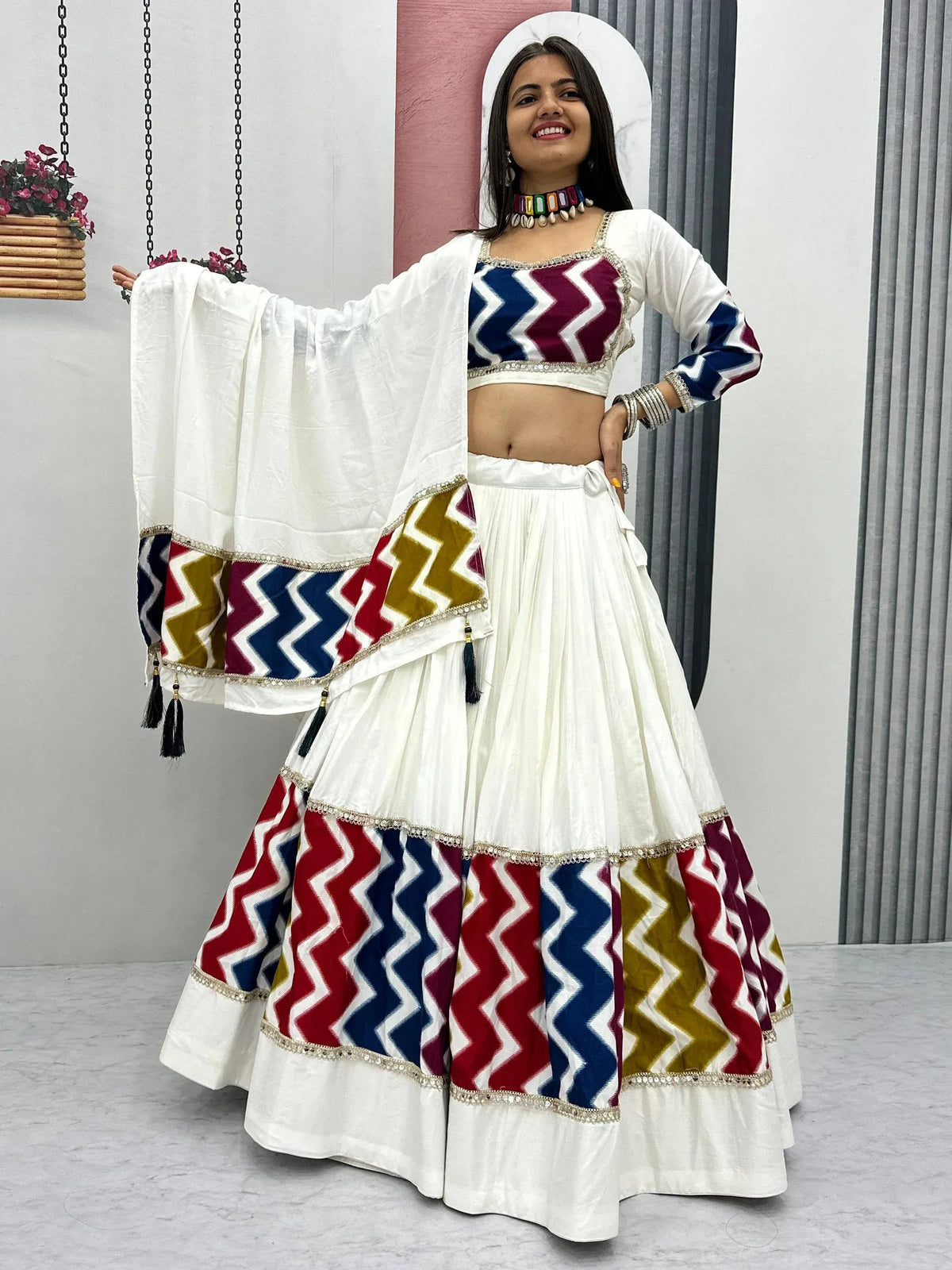 White lehenga choli with colorful zigzag print, perfect for Indian ethnic wear and festive occasions.