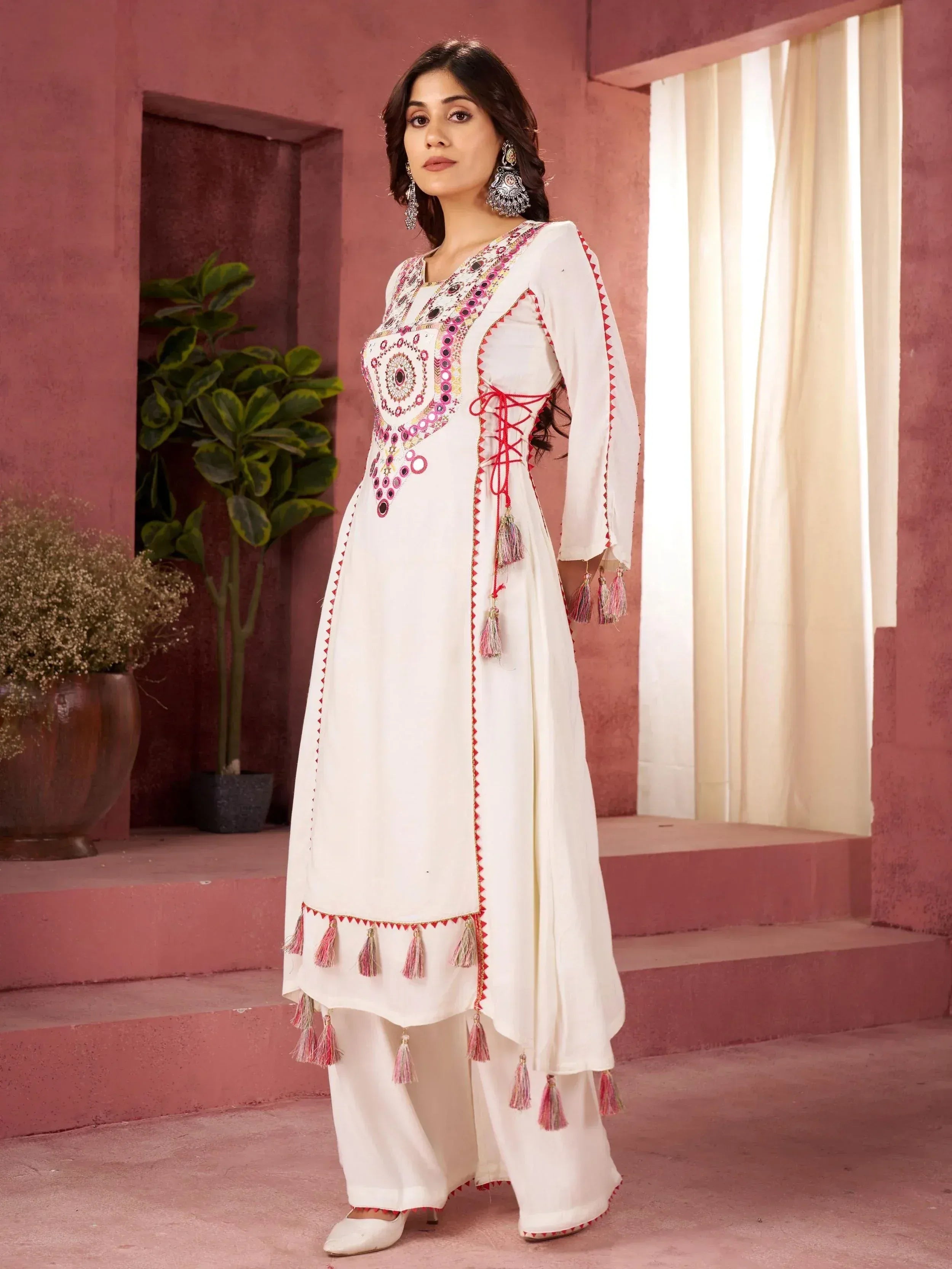 White embroidered ethnic kurta with tassels and mirror work, paired with palazzo pants for Indian wear