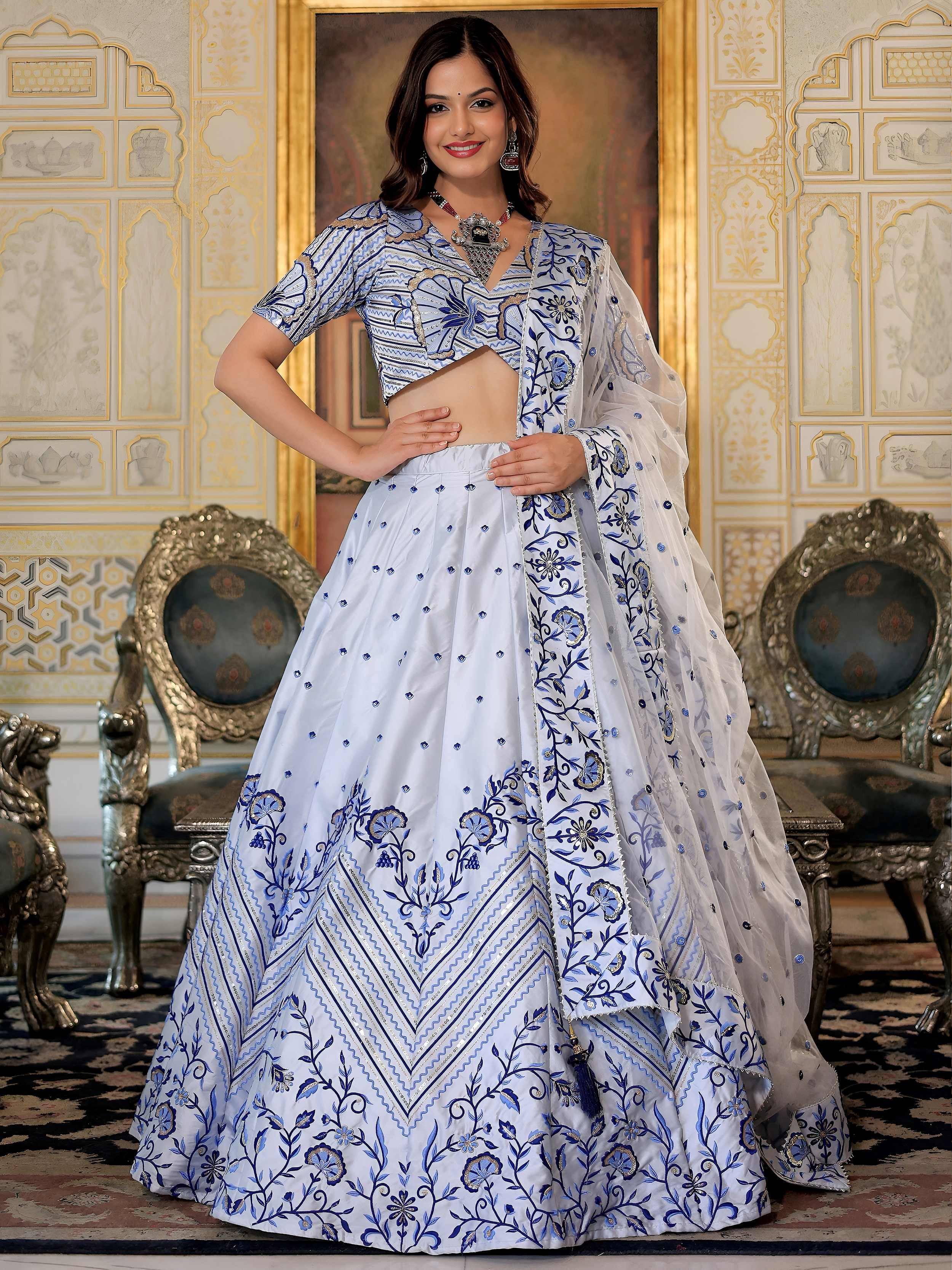 Blue and white embroidered lehenga choli with floral motifs, perfect for Indian ethnic occasions.