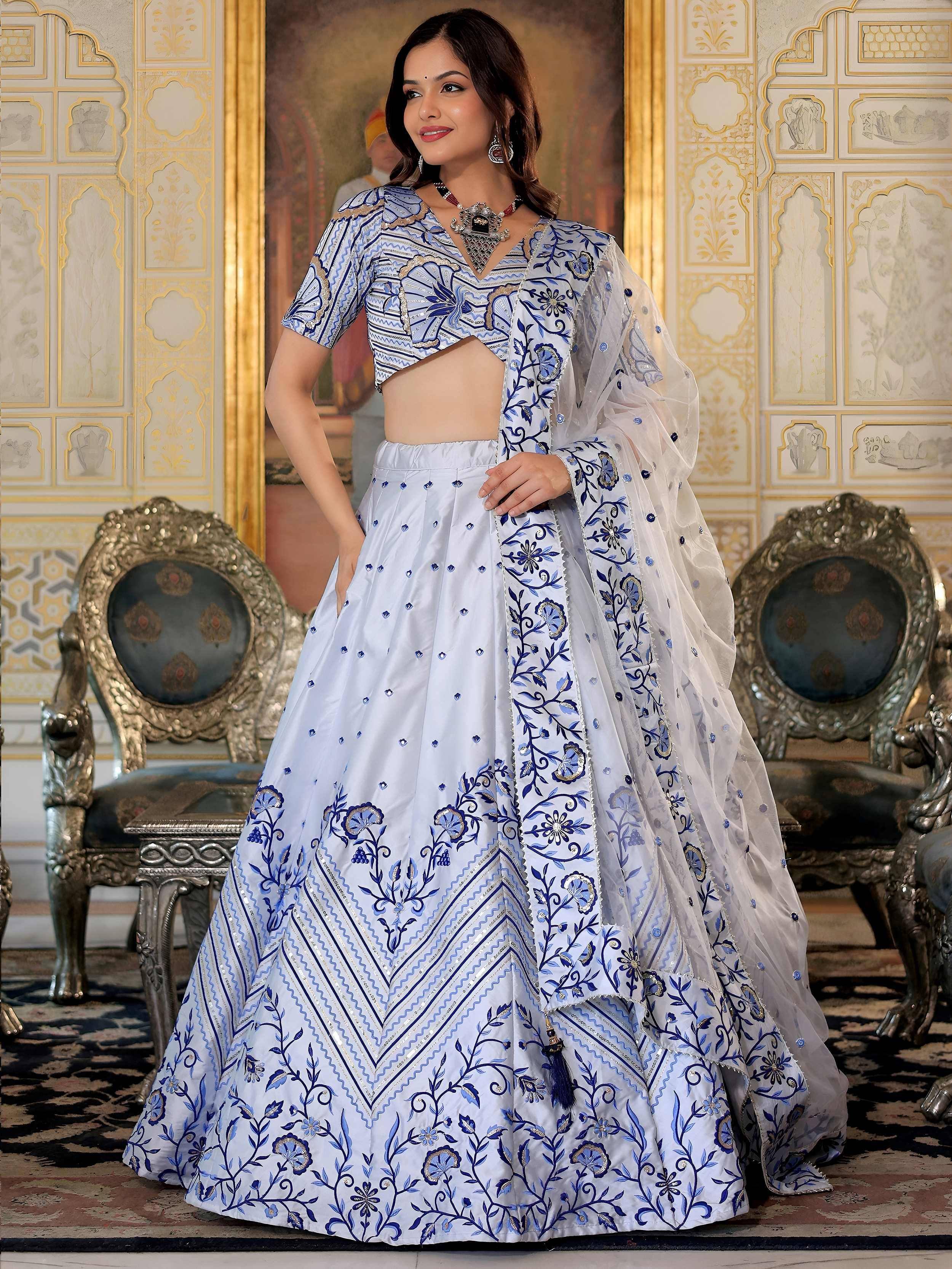 Blue and white embroidered lehenga choli with floral patterns, perfect for Indian ethnic wear events