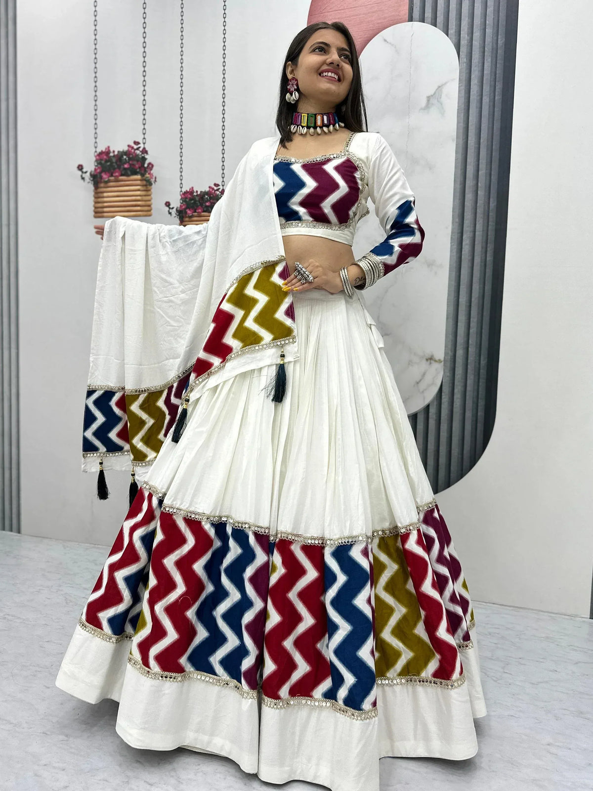 White lehenga choli with colorful zigzag print, perfect for Indian ethnic wear and festive occasions.