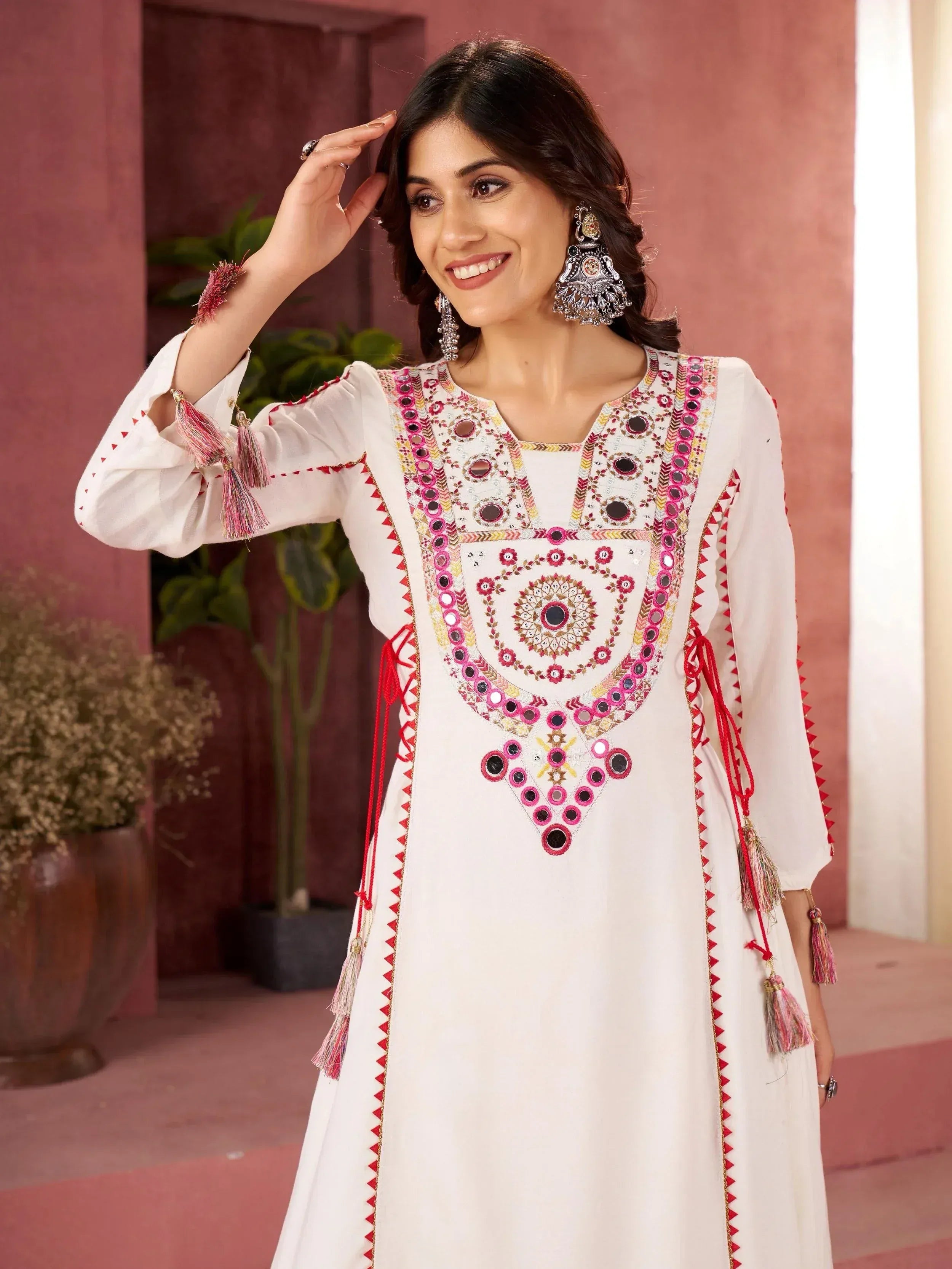 White ethnic kurti with mirror work, tassels, and embroidery for Indian wear