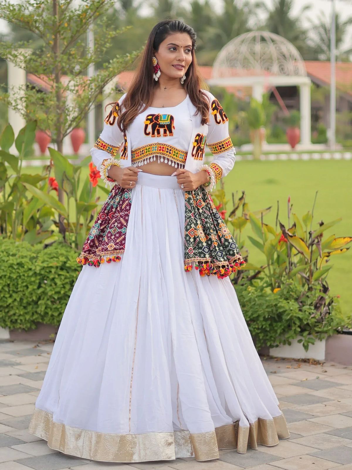 White ethnic lehenga choli with elephant embroidery and colorful dupatta, perfect for Indian festivals and weddings.