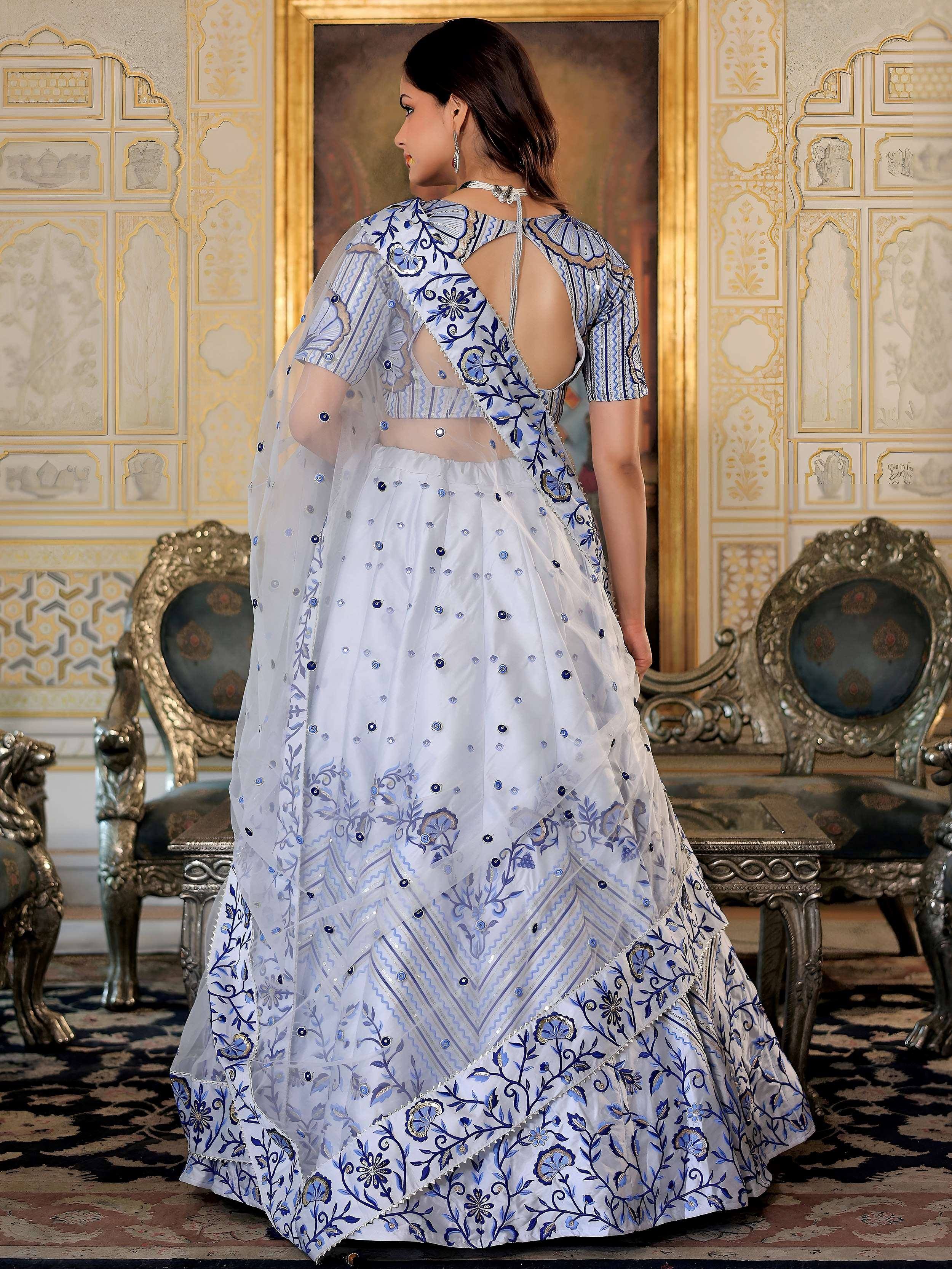 White and blue embroidered lehenga choli with backless blouse, perfect for Indian ethnic wear occasions.