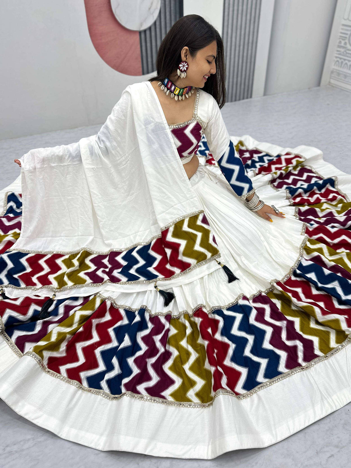 White lehenga choli with colorful zigzag print, perfect for Indian ethnic wear and festive occasions.