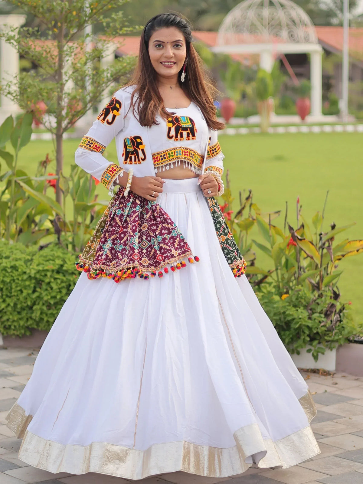 White ethnic lehenga choli with elephant embroidery and colorful dupatta, perfect for Indian festivals and weddings
