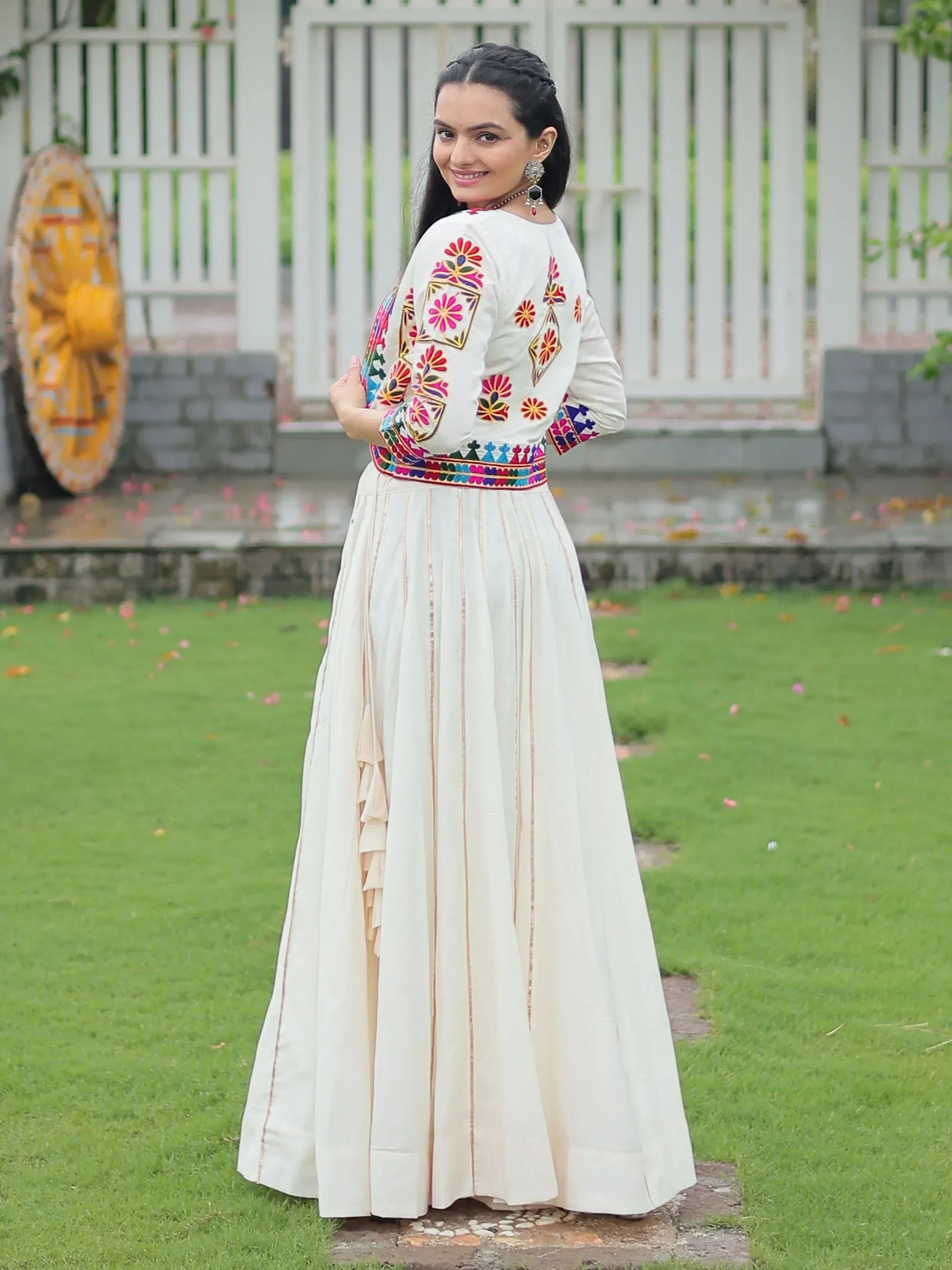 White embroidered ethnic gown with floral motifs, perfect for Indian occasions and festive wear.