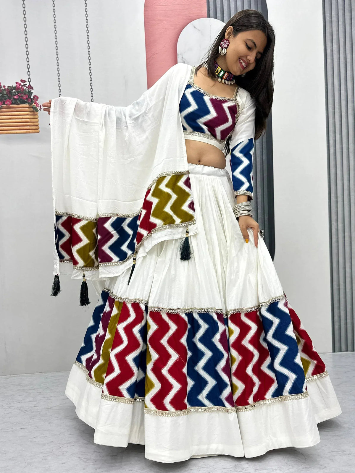 White lehenga choli with colorful zigzag print, perfect for Indian ethnic wear and festive occasions