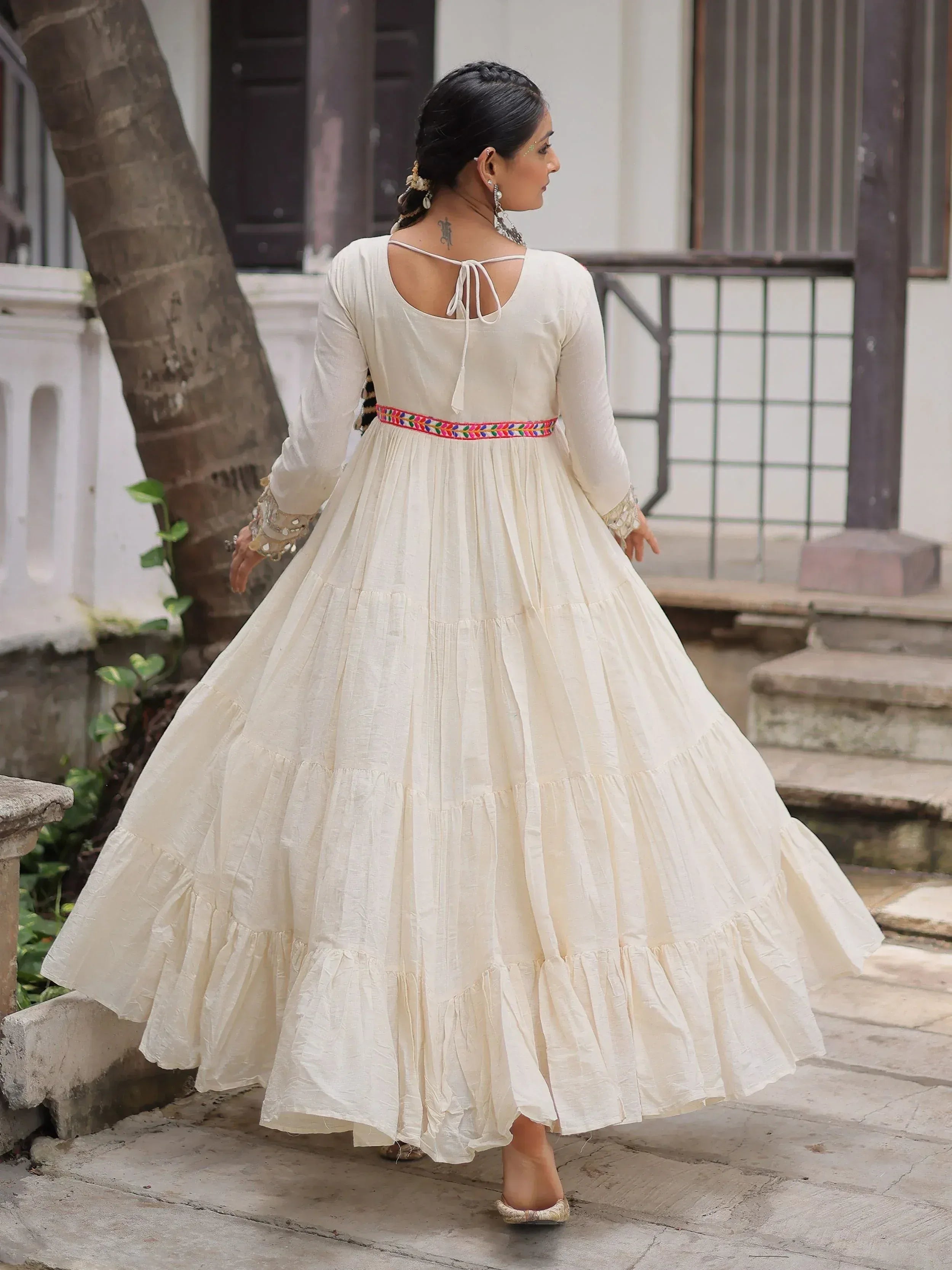 Cream ethnic gown with tiered skirt, colorful waistband, and back tie detail for women