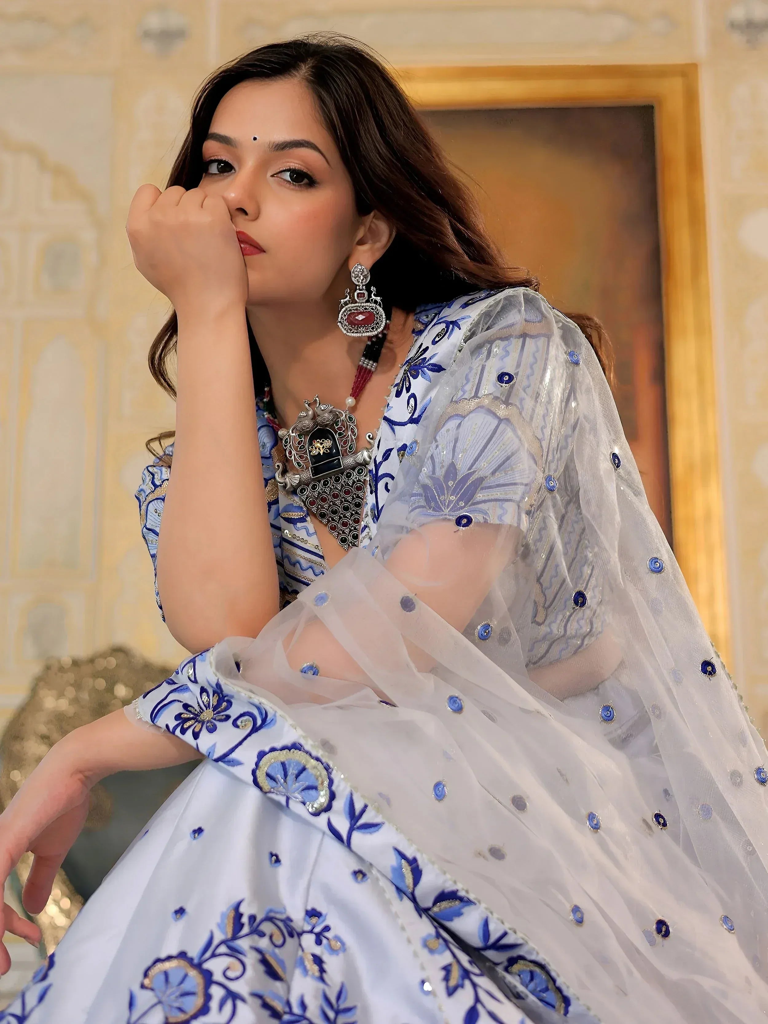Elegant white and blue embroidered lehenga choli with sheer dupatta, perfect for Indian ethnic wear occasions.