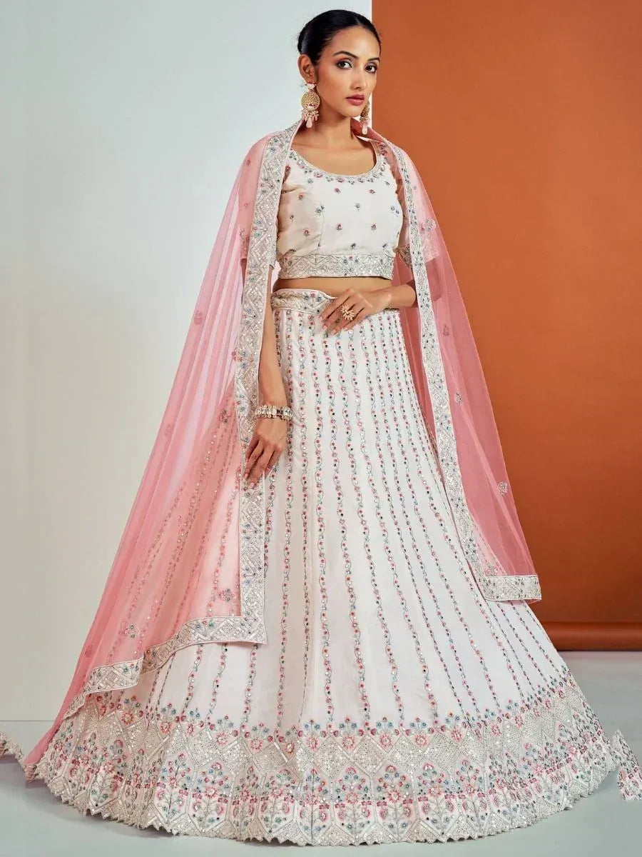Elegant white lehenga choli with pink dupatta, perfect for Indian weddings and festive occasions.