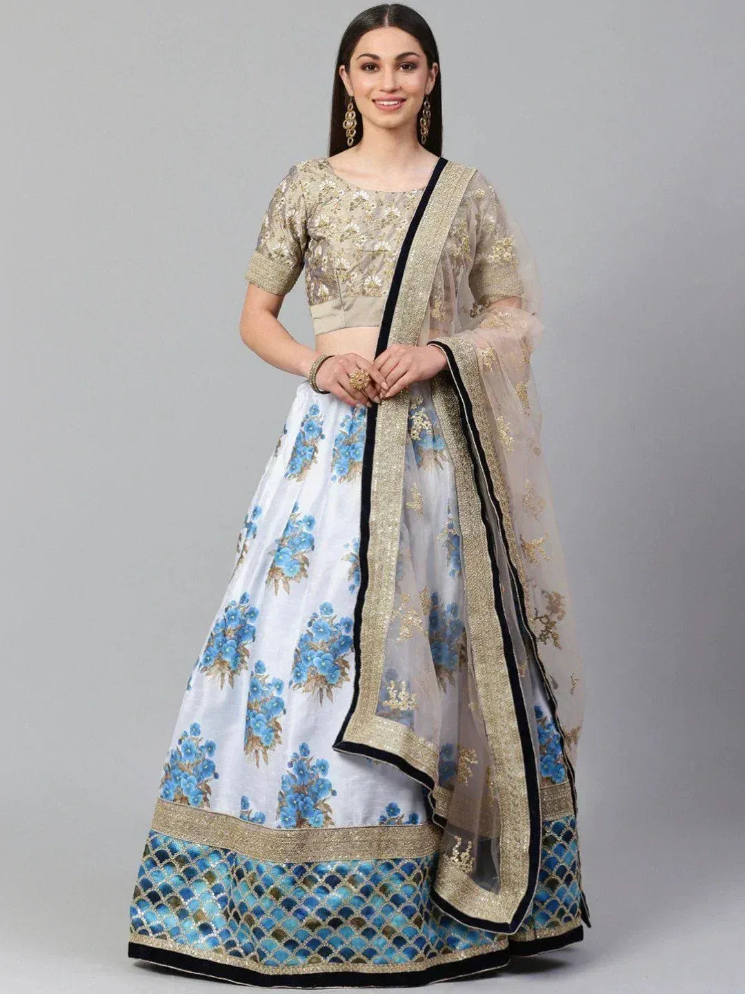 White lehenga choli with blue floral print and gold embroidery, perfect for Indian ethnic wear occasions