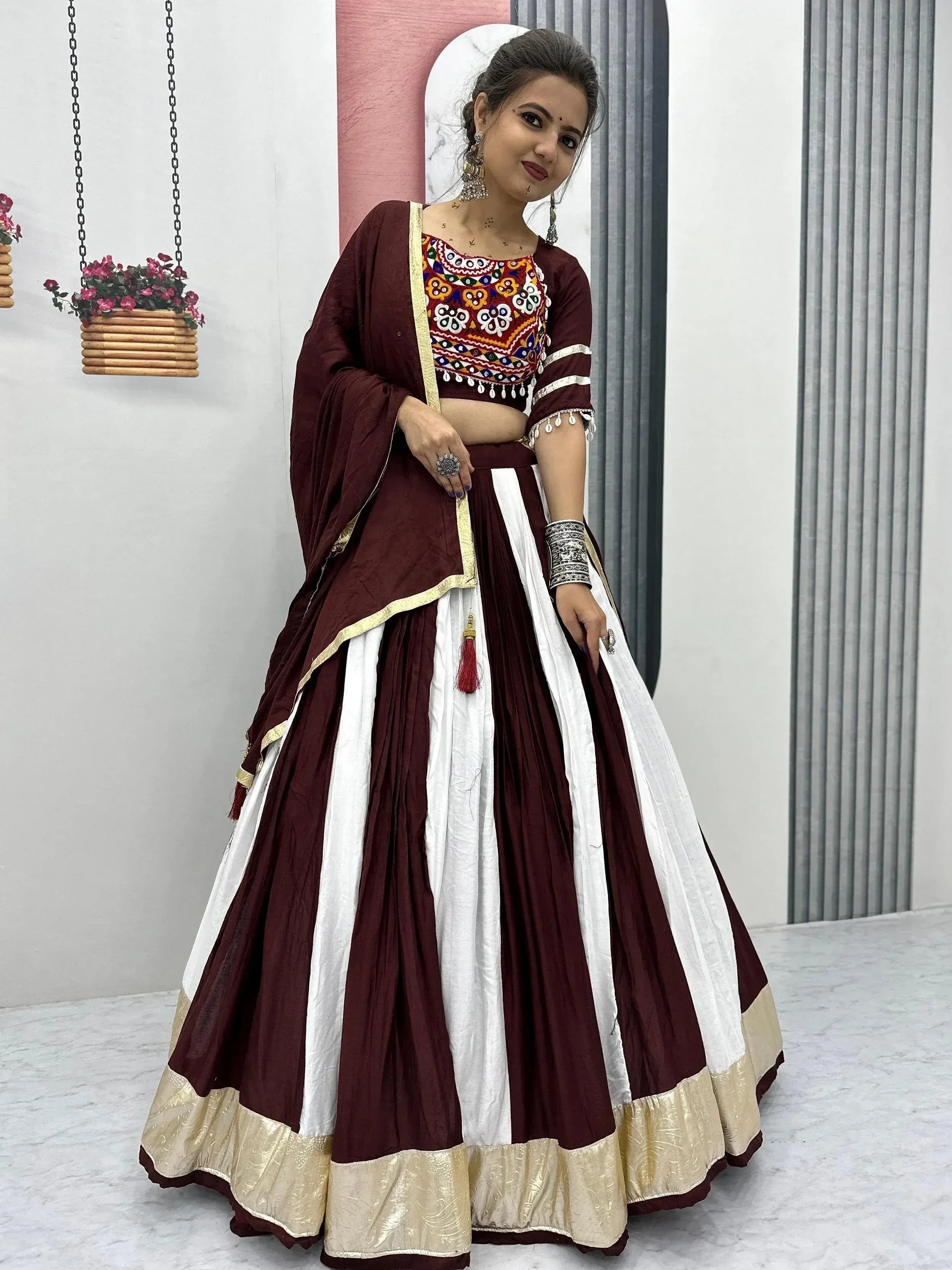 Maroon and white embroidered lehenga choli with gold trim, perfect for Indian ethnic wear occasions.