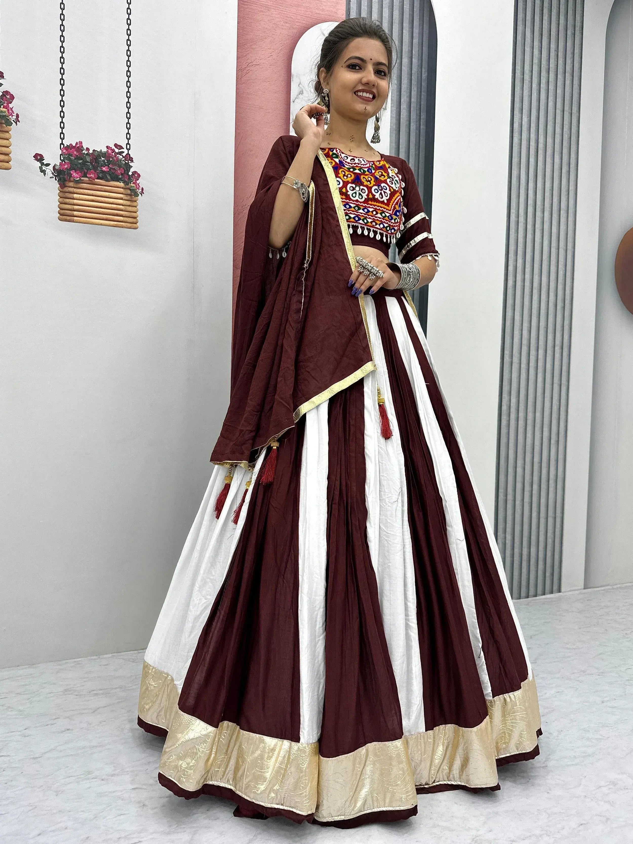 Maroon and white embroidered lehenga choli with gold border, perfect for Indian ethnic wear occasions.