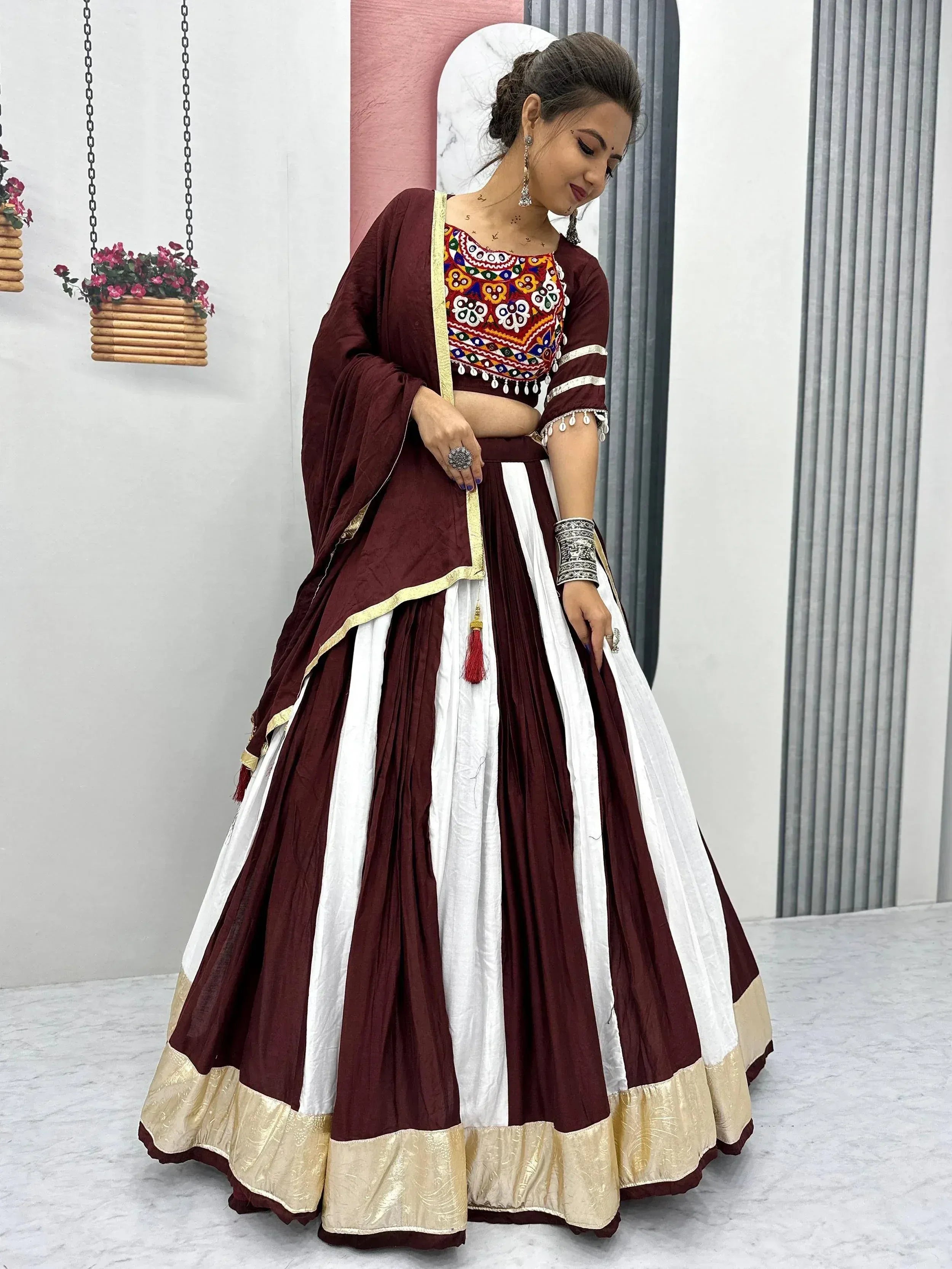 Maroon and white embroidered lehenga choli with gold trim, perfect for Indian ethnic wear occasions