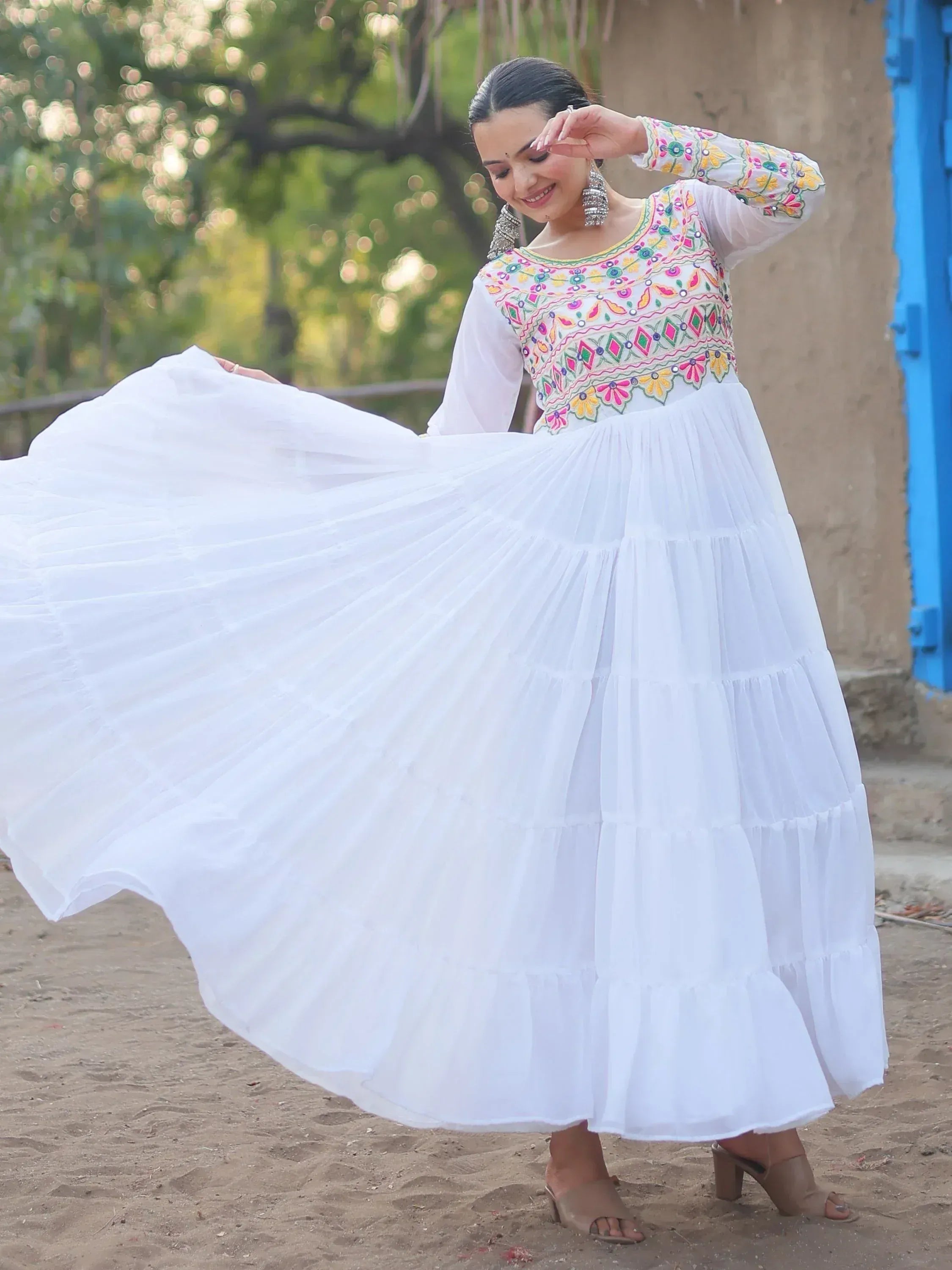 White ethnic gown with colorful embroidery, flared skirt, perfect for Indian festive occasions
