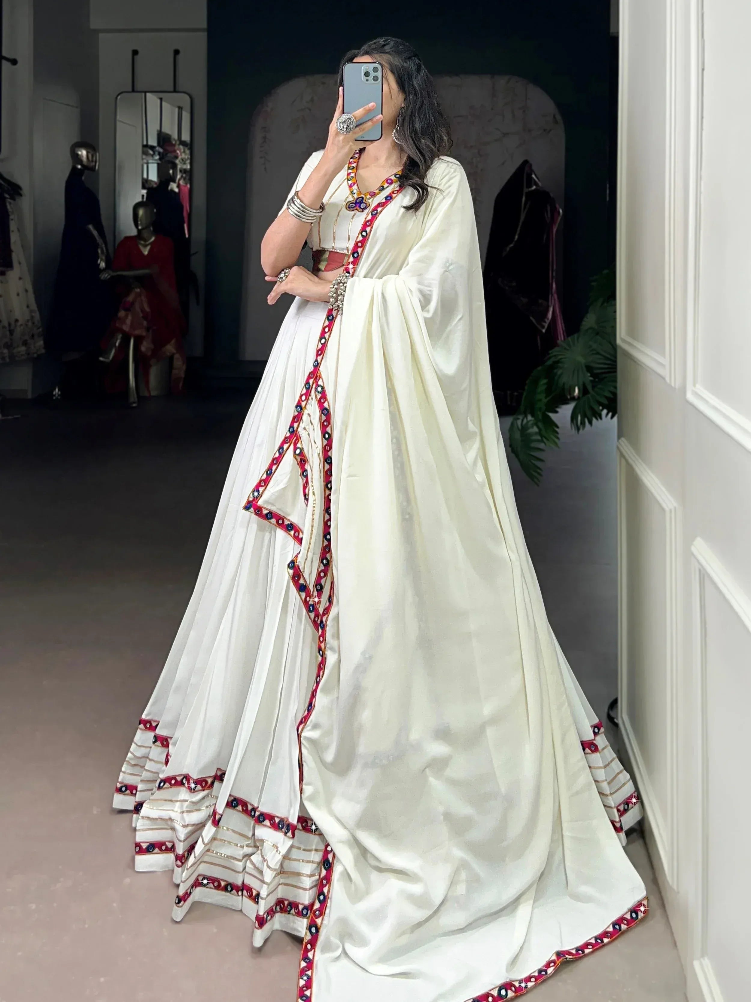 White embroidered lehenga choli with colorful mirror work, perfect for Indian ethnic wear and festive occasions.