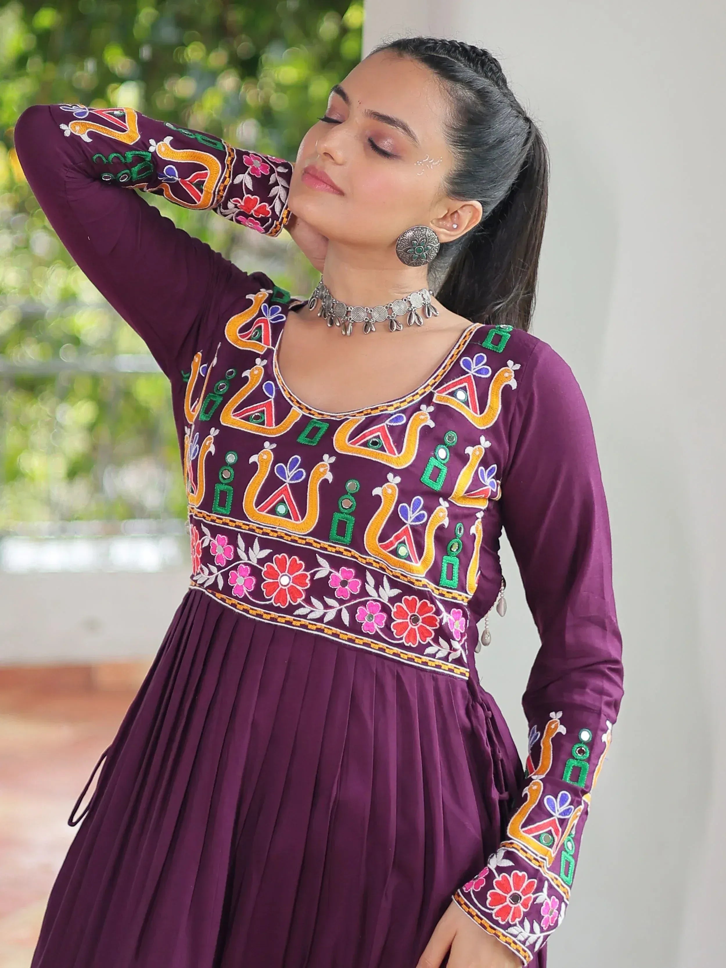 Purple embroidered ethnic gown with floral and peacock motifs, perfect for Indian festive wear