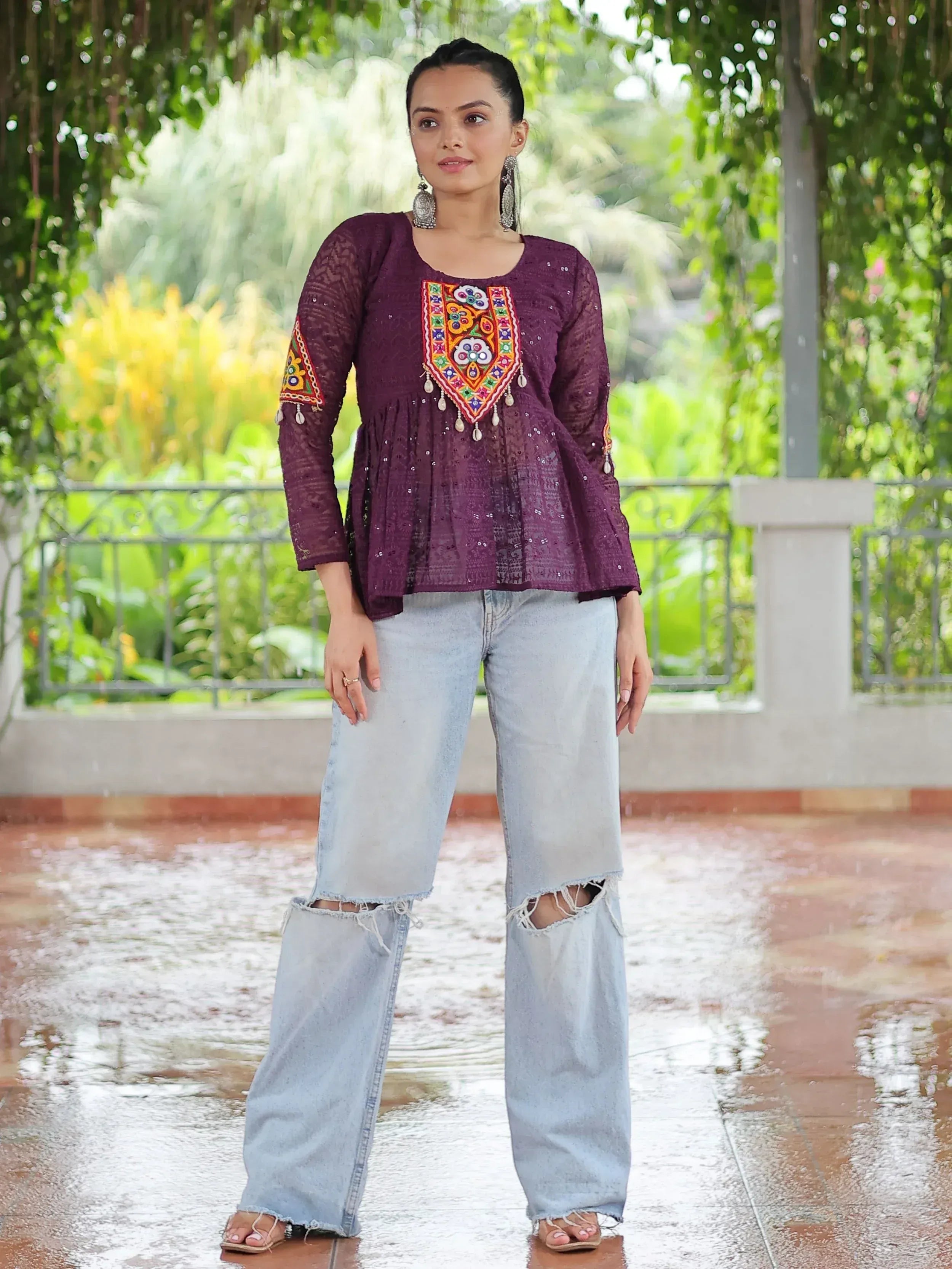 Purple embroidered ethnic top with mirror work, paired with ripped wide-leg jeans for casual wear