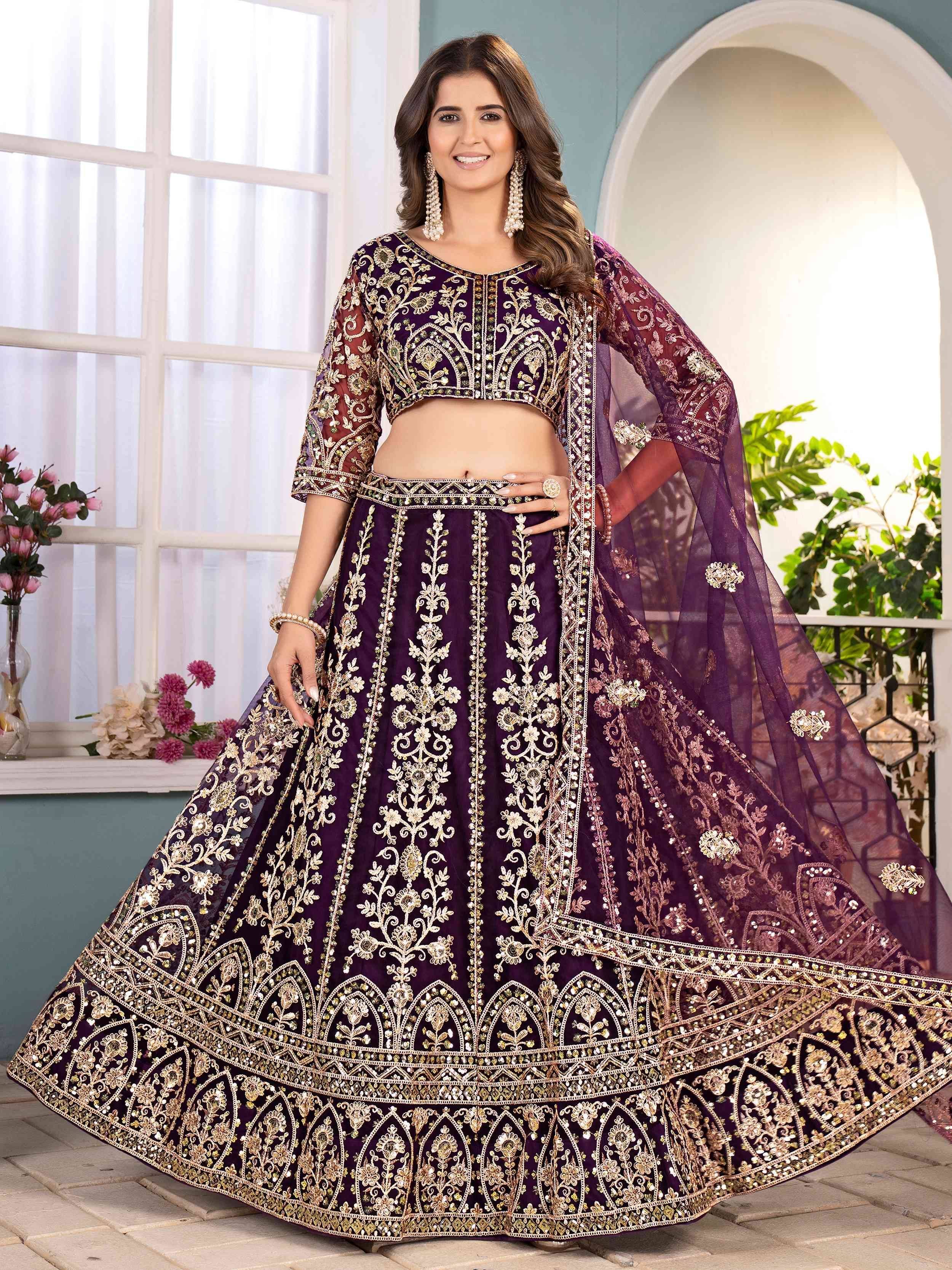 Purple designer lehenga choli with gold embroidery, perfect for Indian weddings and festive occasions.