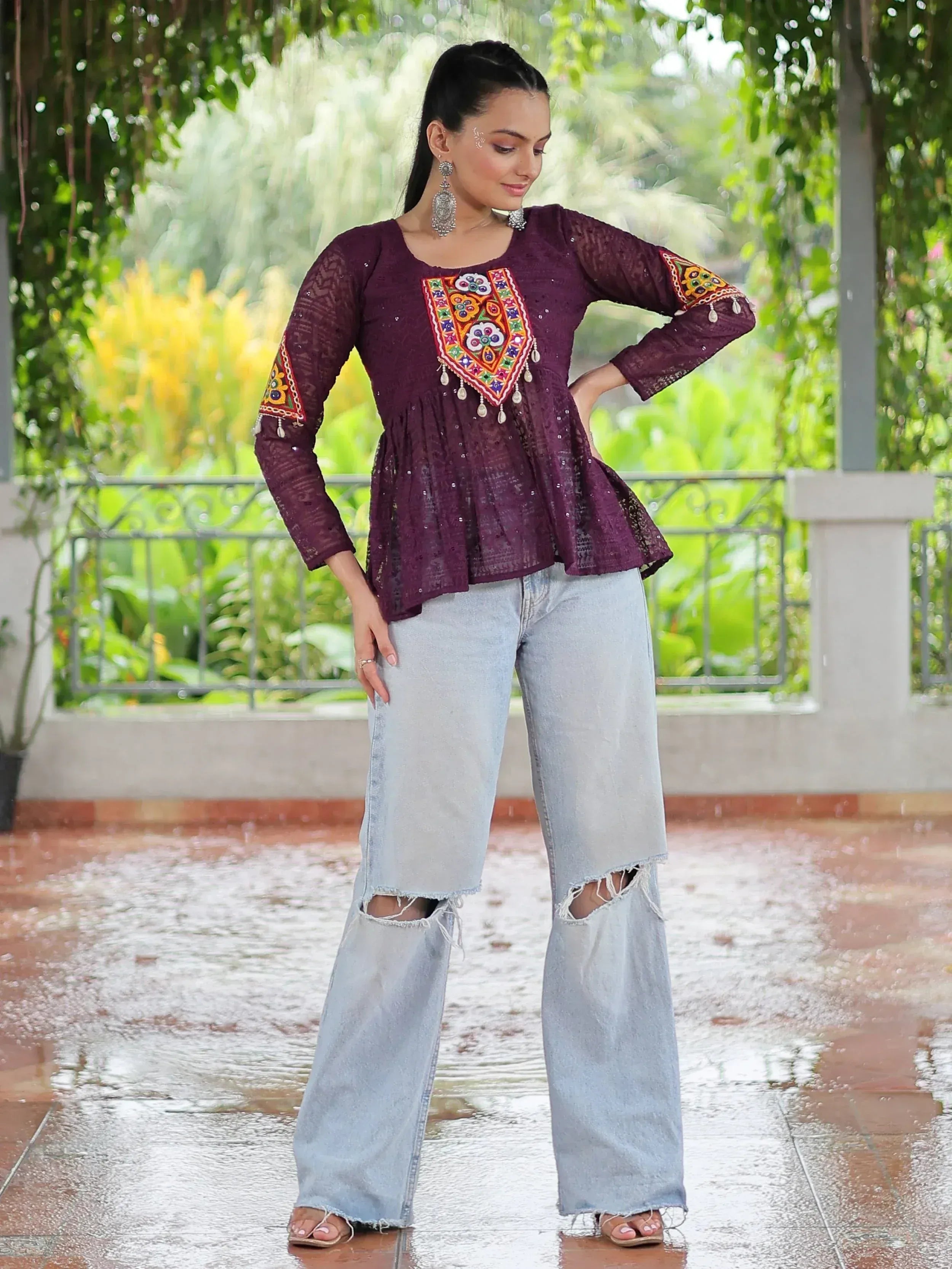 Purple embroidered ethnic top with lace sleeves paired with ripped wide-leg jeans, styled for casual wear.