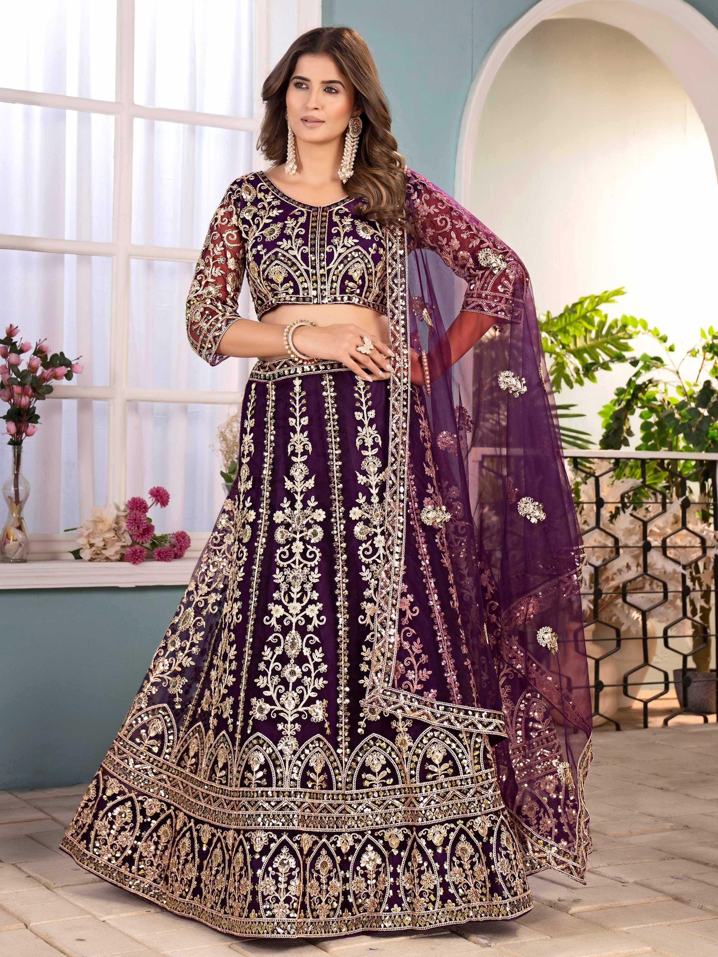 Purple designer lehenga choli with gold embroidery, perfect for weddings and festive occasions.