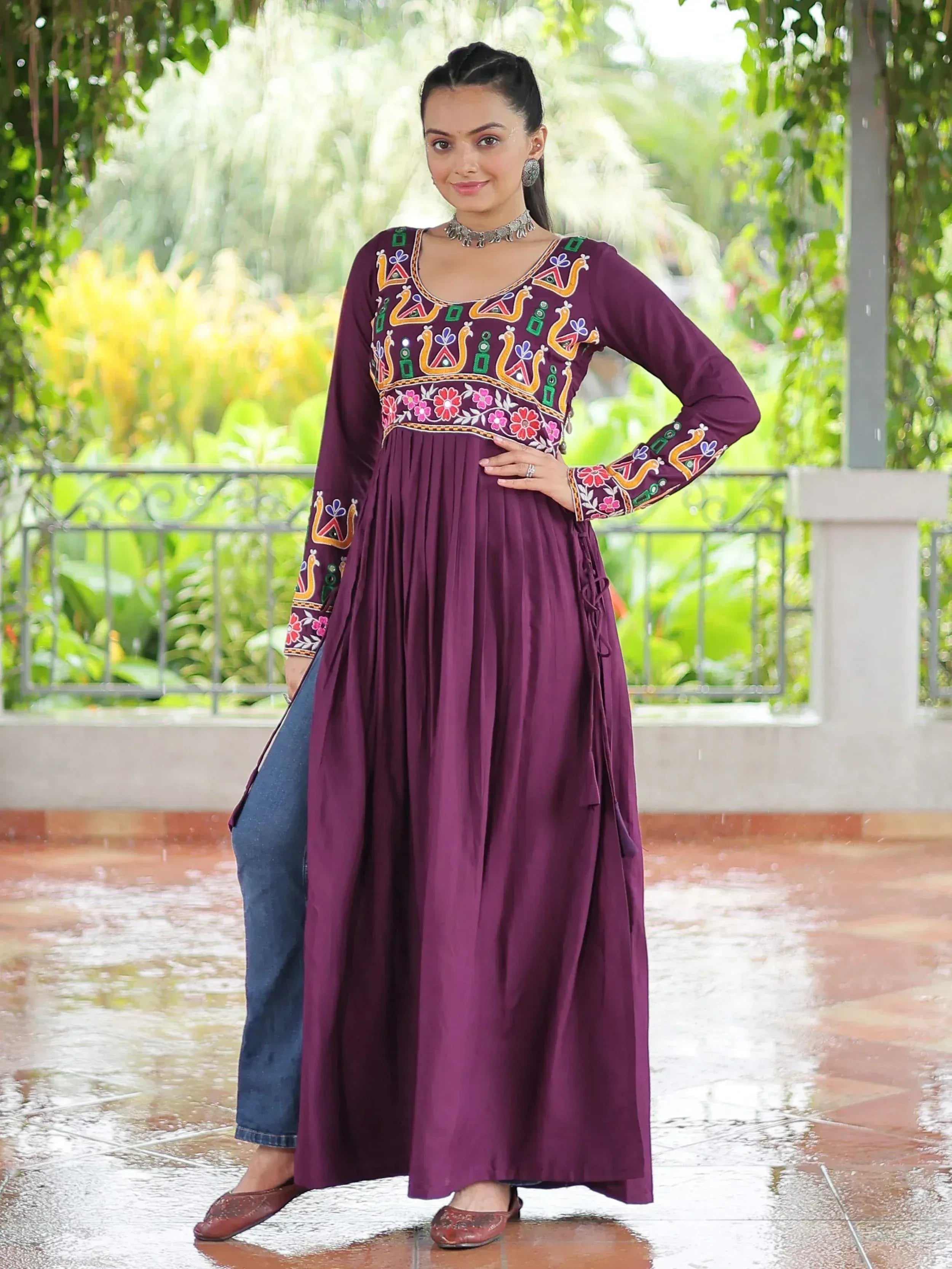 Purple embroidered ethnic anarkali with floral motifs, paired with jeans, perfect for Indian festive wear.
