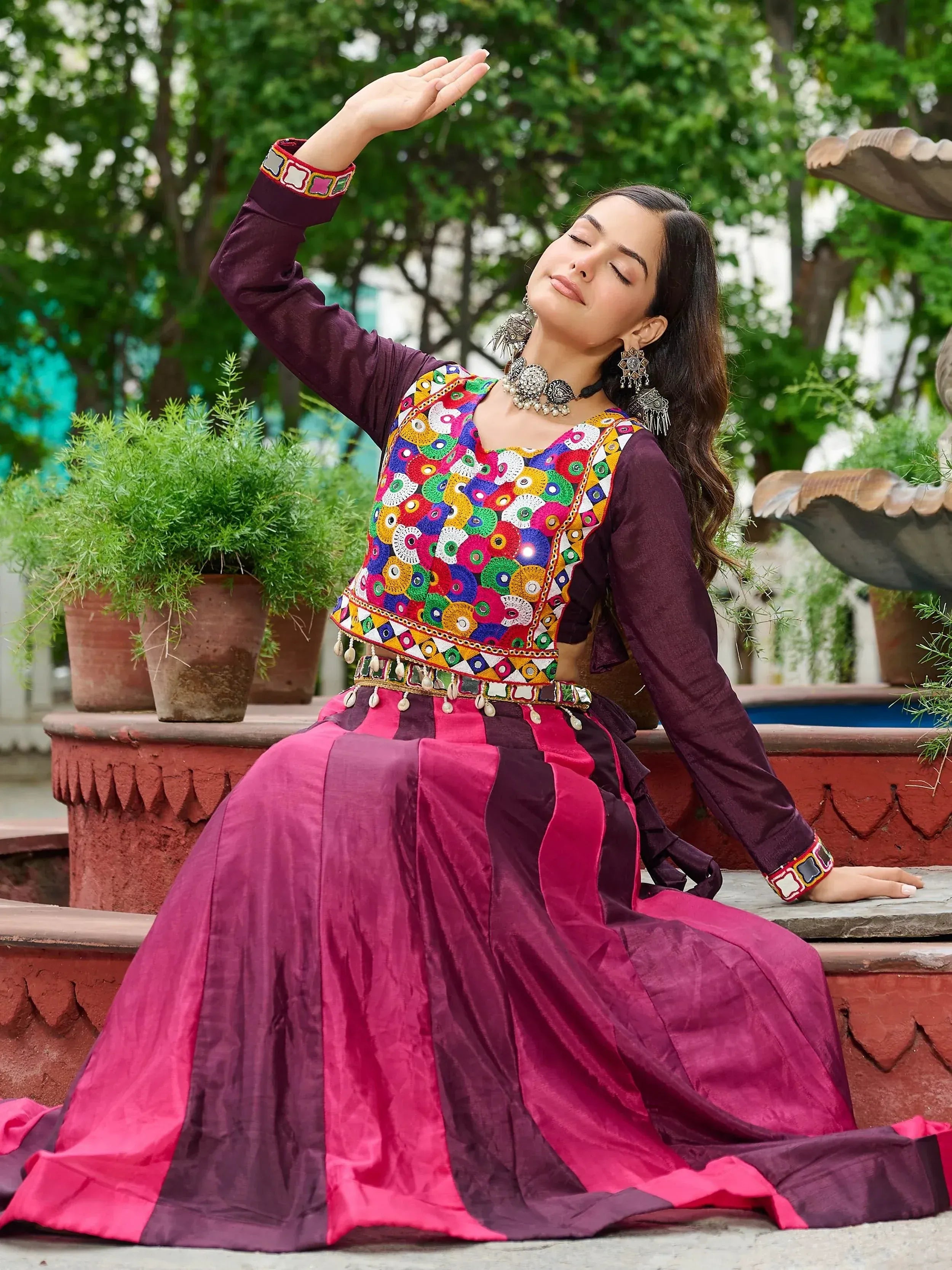 Woman in vibrant ethnic Indian lehenga choli with mirror work, perfect for festive occasions and traditional events.
