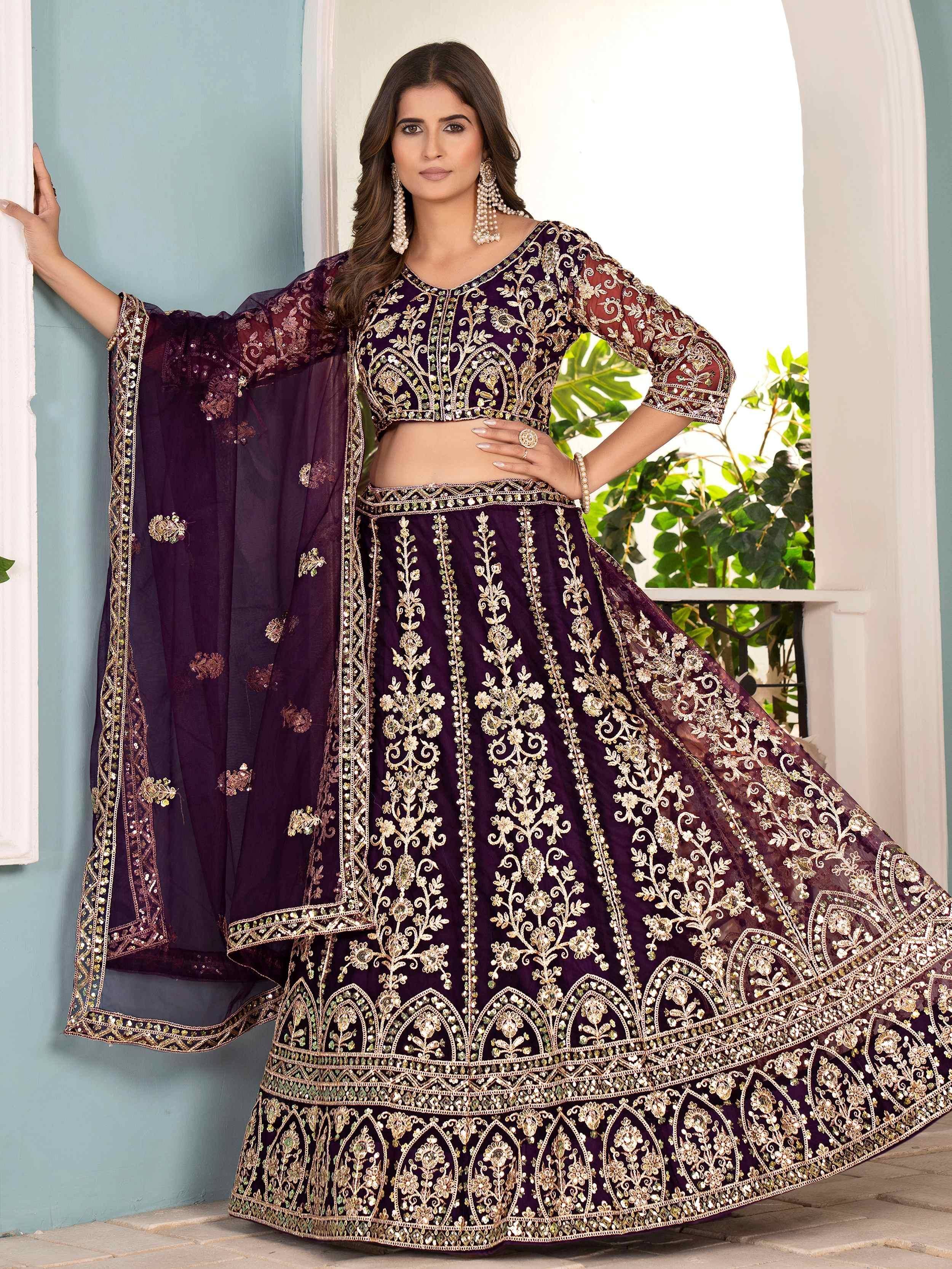 Elegant purple designer lehenga choli with gold embroidery and sheer dupatta, perfect for Indian weddings and festive occasions.
