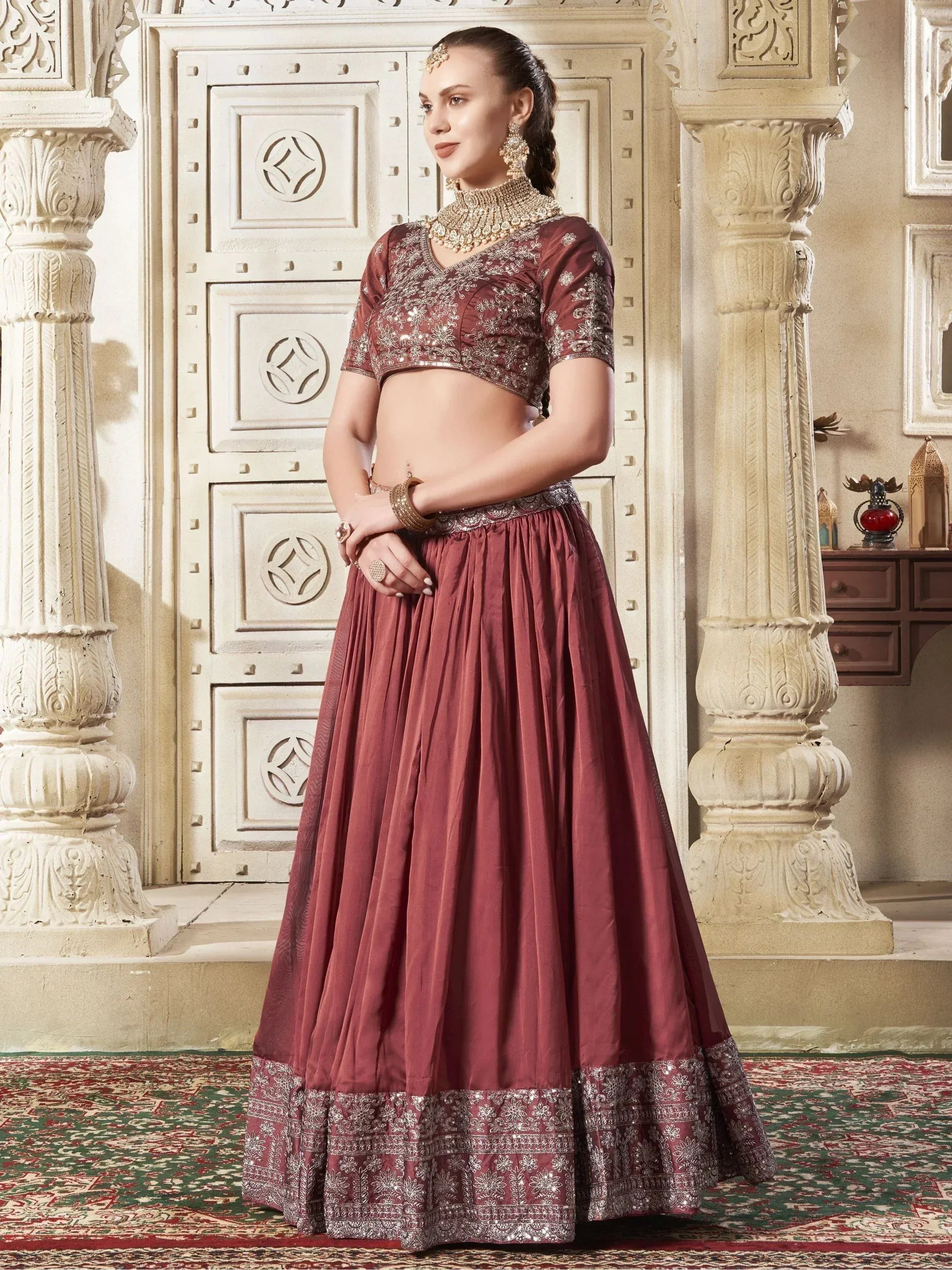 Maroon embroidered lehenga choli with silver detailing, perfect for Indian ethnic wear occasions