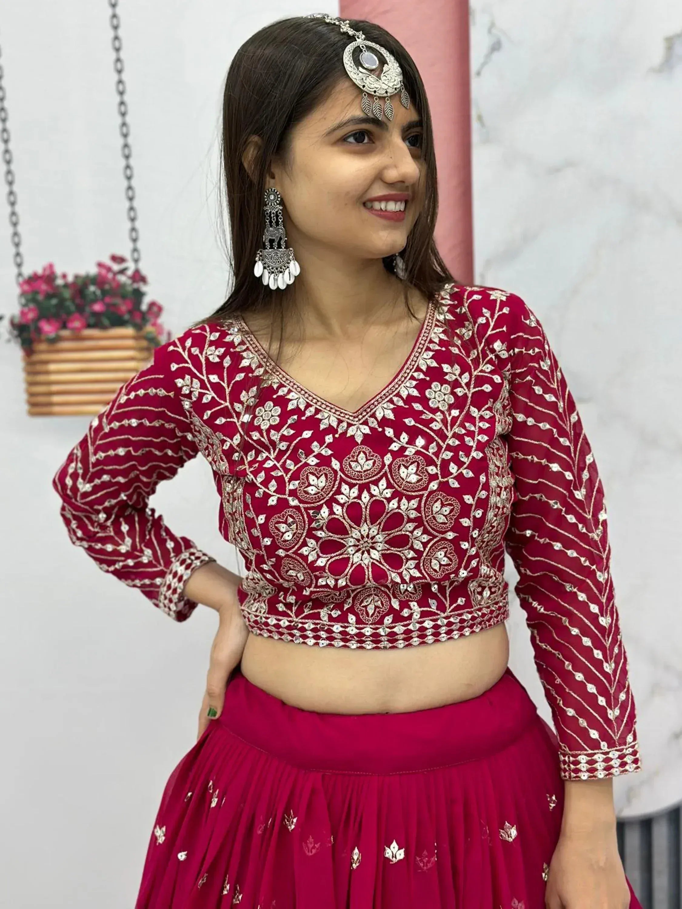 Red embroidered lehenga choli with mirror work, traditional Indian ethnic wear for women