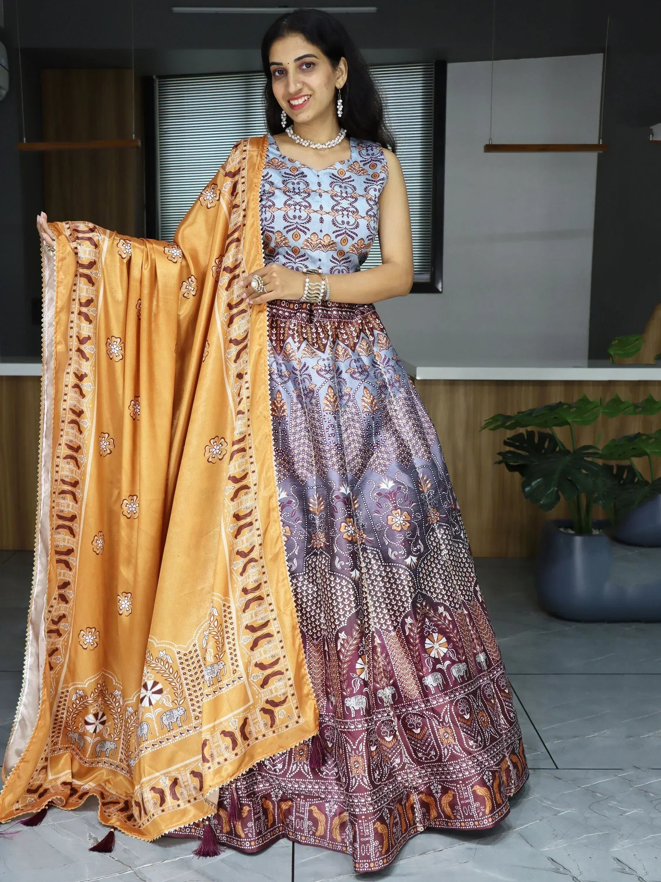 Woman in printed lehenga choli with matching dupatta, ethnic Indian wear for festive occasions
