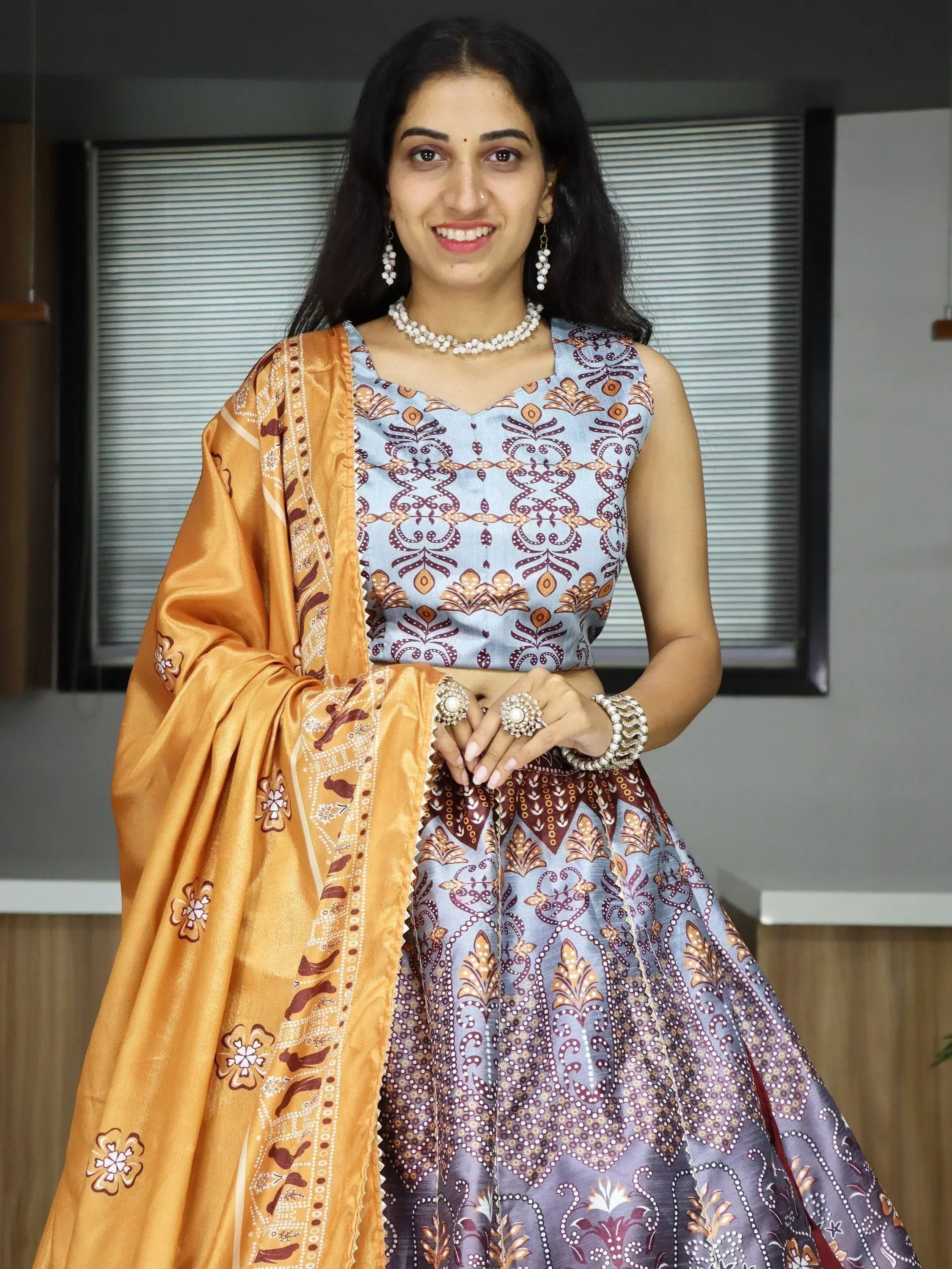 Woman in blue and gold printed lehenga choli with matching dupatta, ethnic Indian wear