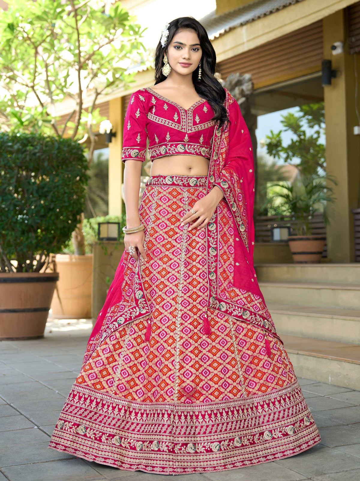 Pink embroidered lehenga choli with geometric patterns, perfect for Indian weddings and festive occasions.