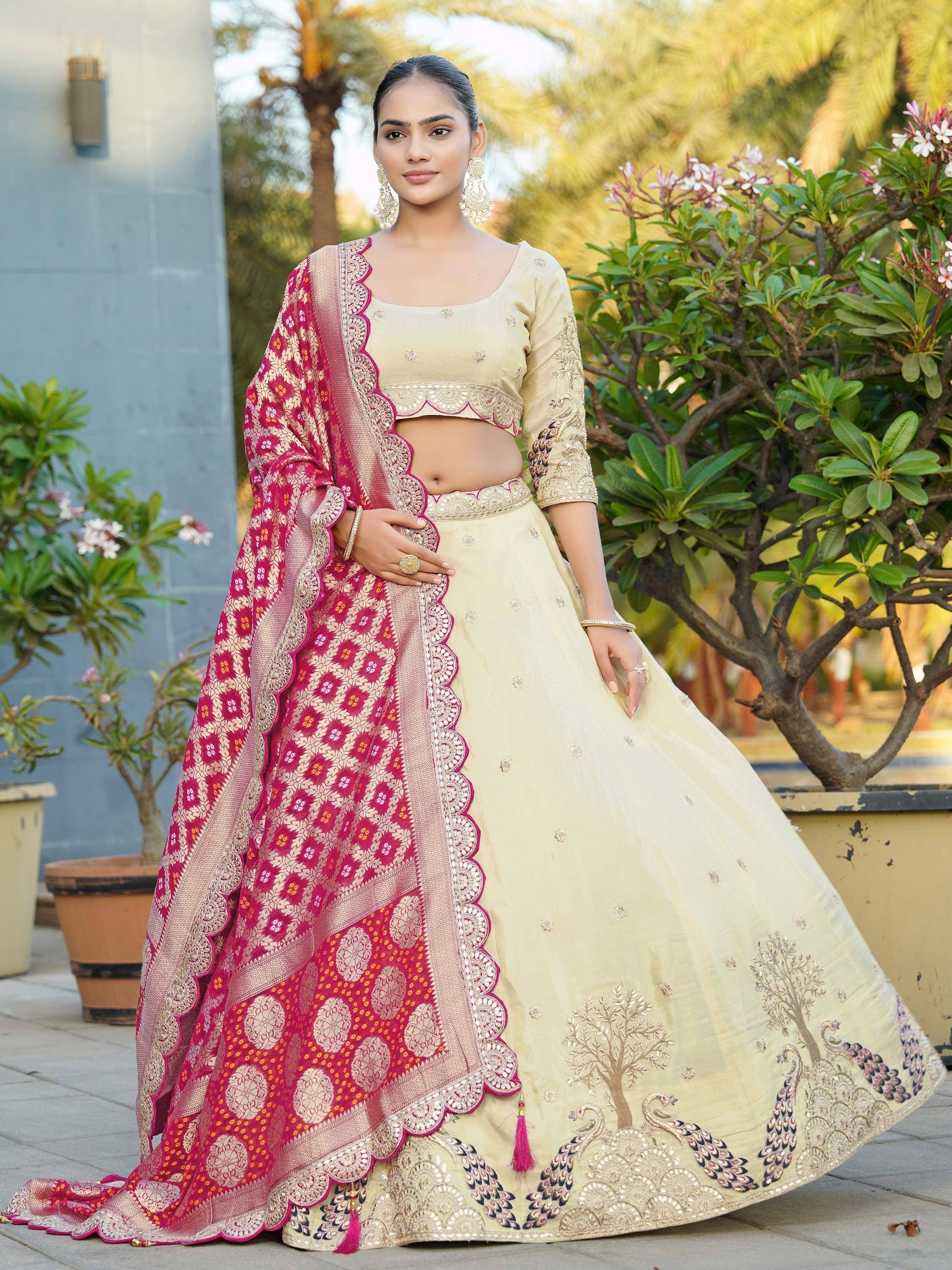 Elegant cream lehenga choli with peacock embroidery and pink dupatta, perfect for Indian weddings and festive occasions.