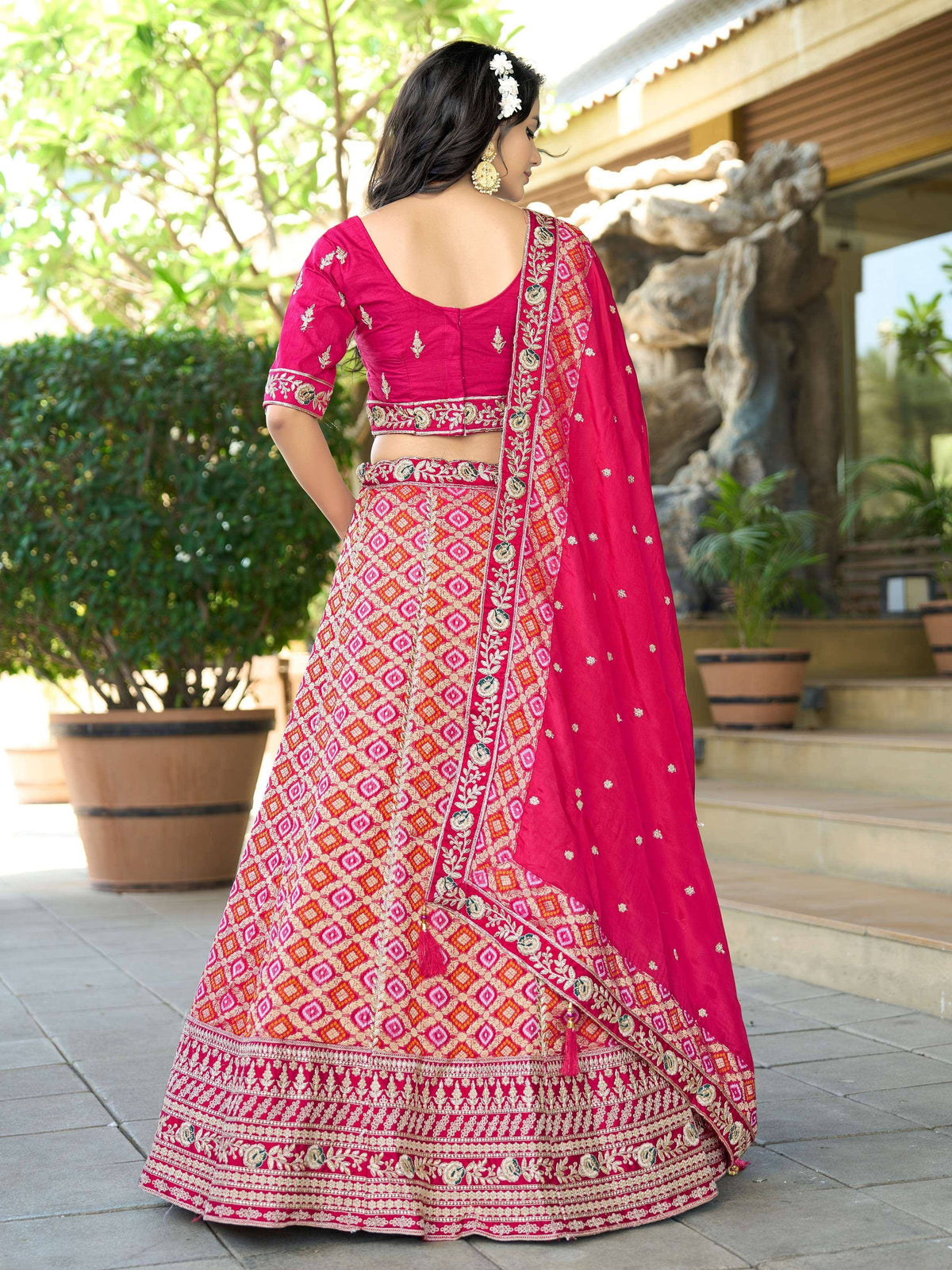 Pink embroidered lehenga choli with floral dupatta, perfect for Indian weddings and festive occasions