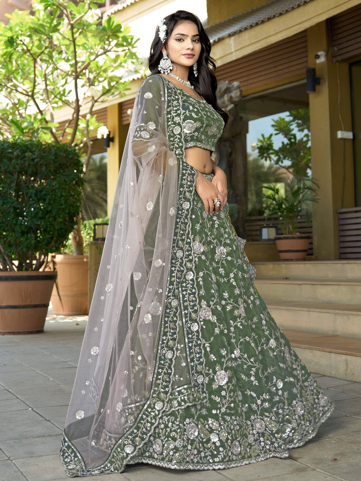 Green embroidered lehenga choli with floral zari work and sheer dupatta, perfect for weddings and festive occasions.