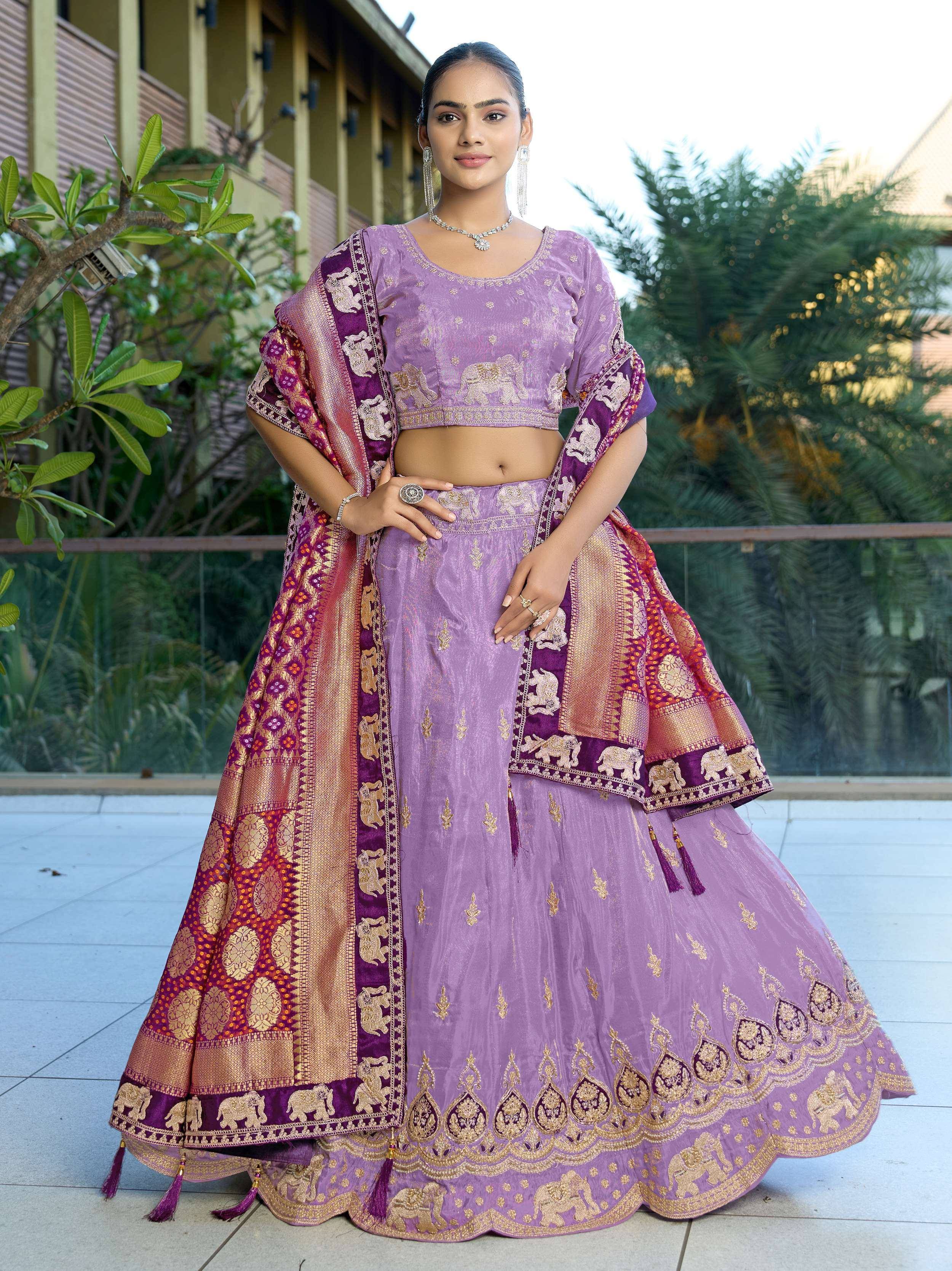 Purple designer lehenga choli with elephant motifs and gold embroidery, perfect for Indian ethnic wear.