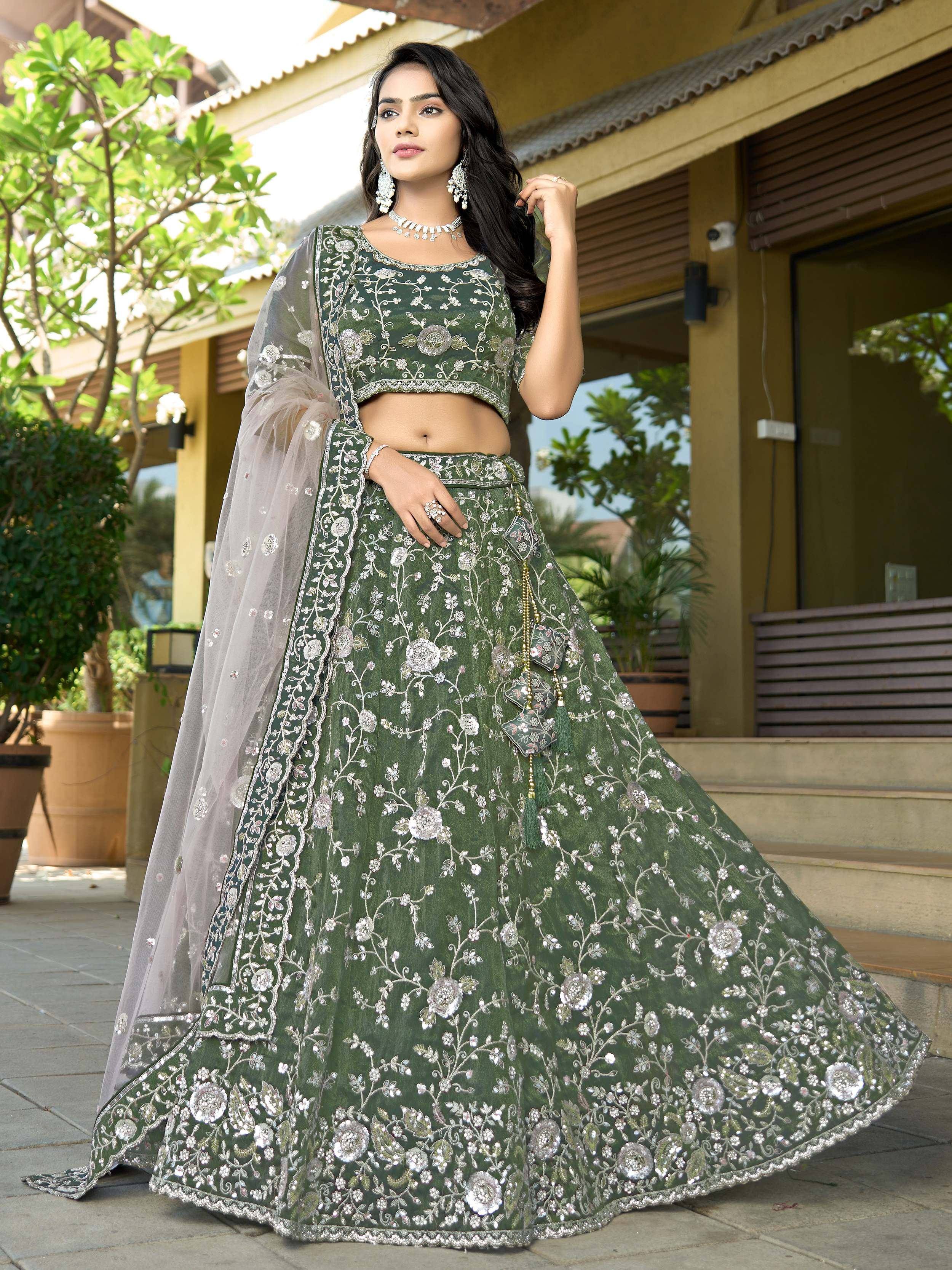 Green embroidered lehenga choli with floral motifs and sheer dupatta, perfect for Indian ethnic occasions.