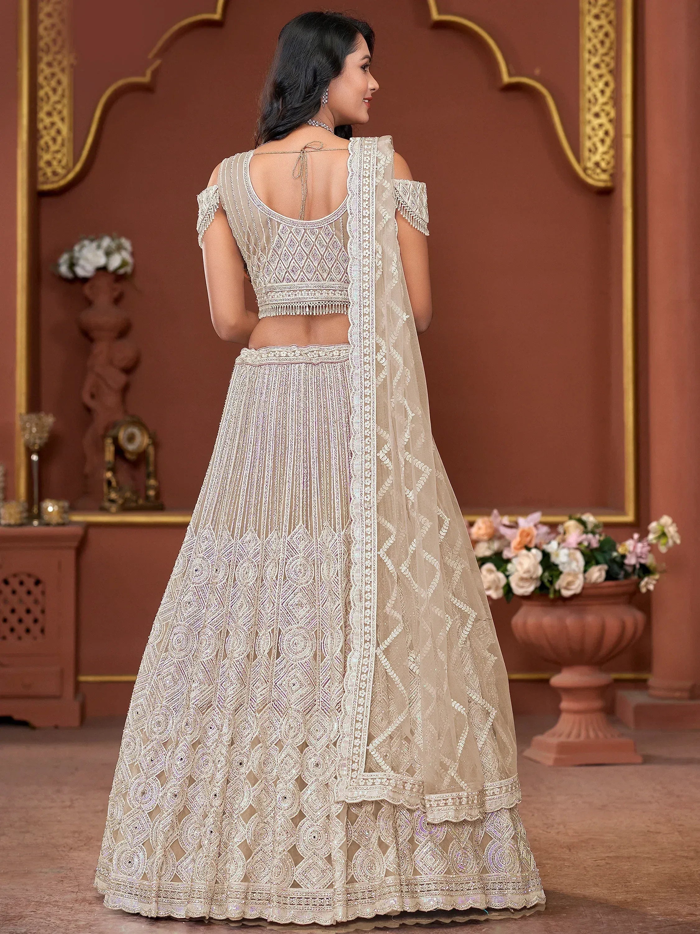 Elegant ivory lehenga choli with intricate embroidery, perfect for Indian weddings and festive occasions.