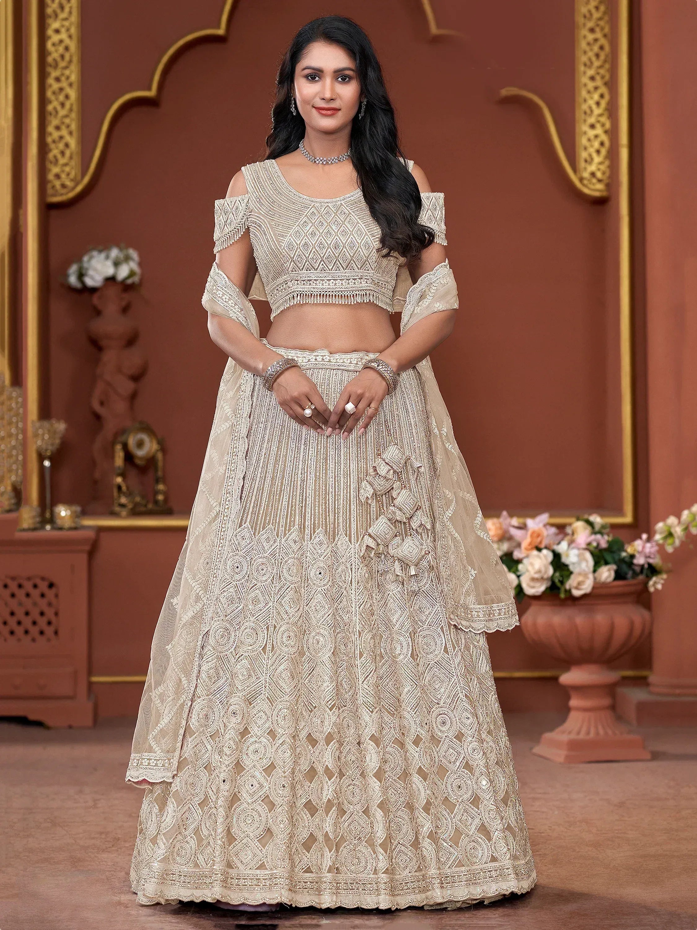 Elegant ivory designer lehenga choli with intricate embroidery and cold shoulder blouse for Indian weddings