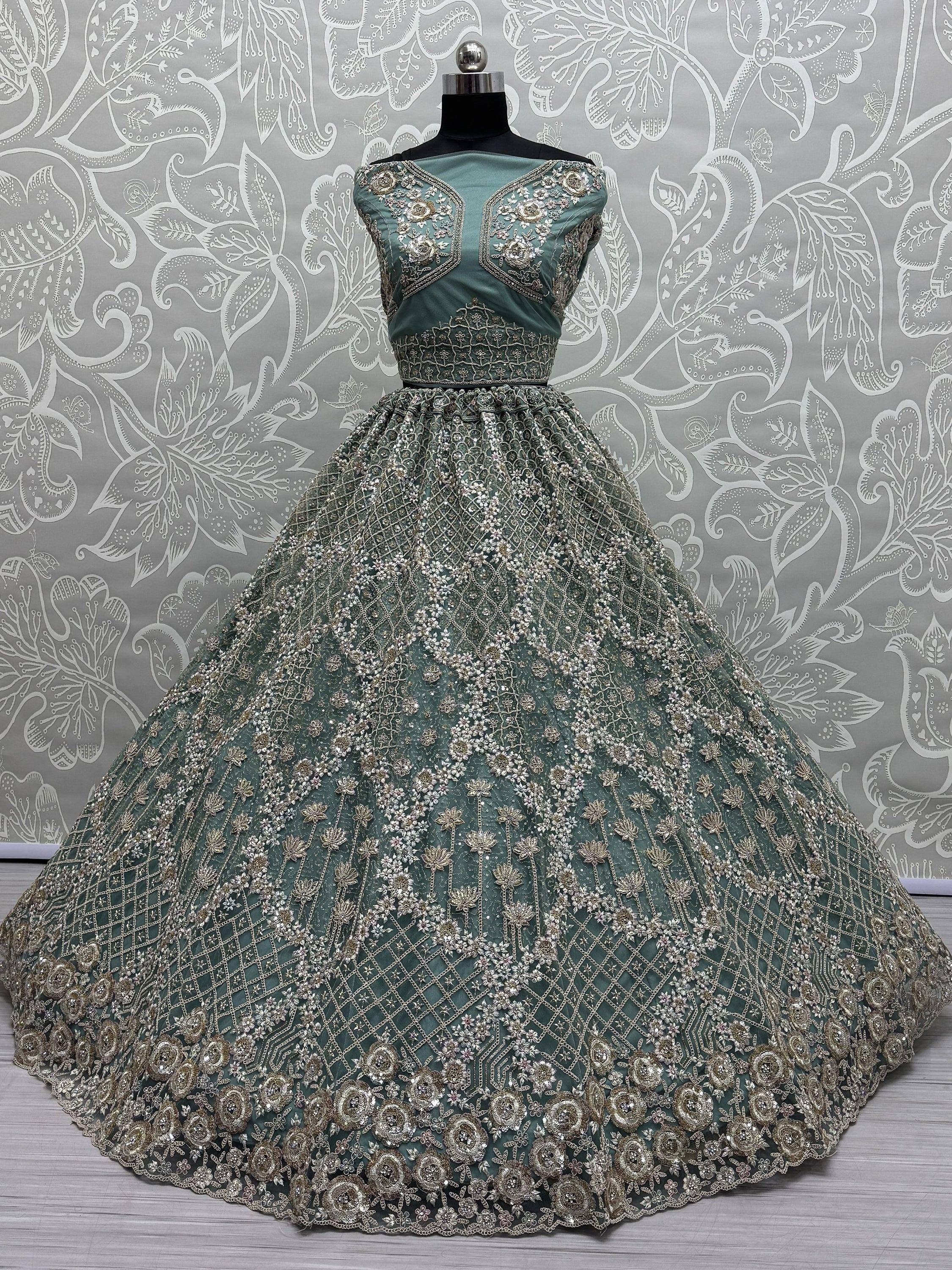 Emerald green designer lehenga with heavy gold embroidery and floral motifs, perfect for Indian weddings.