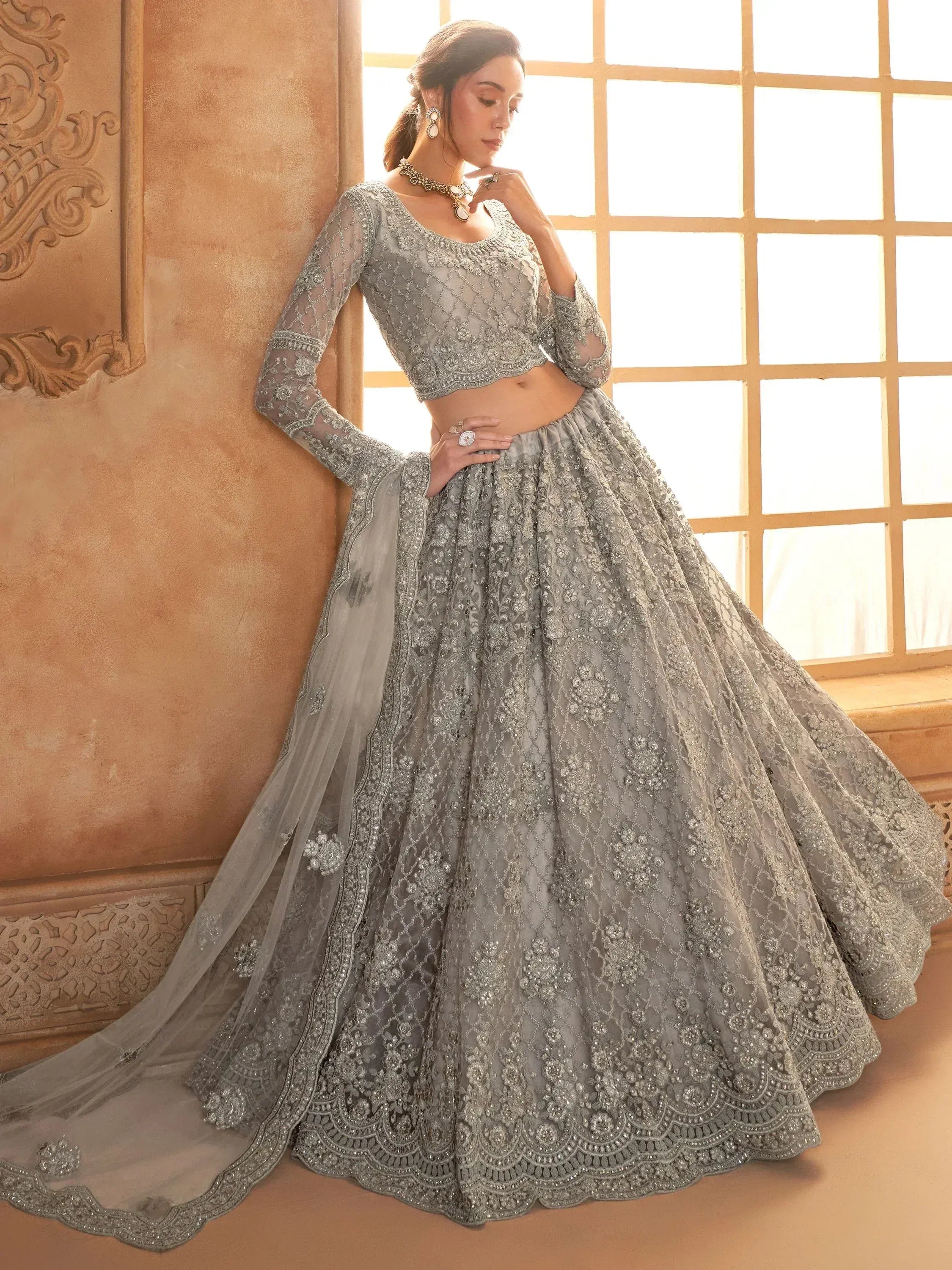 Elegant grey embroidered lehenga choli with sheer dupatta, perfect for Indian weddings and festive occasions.