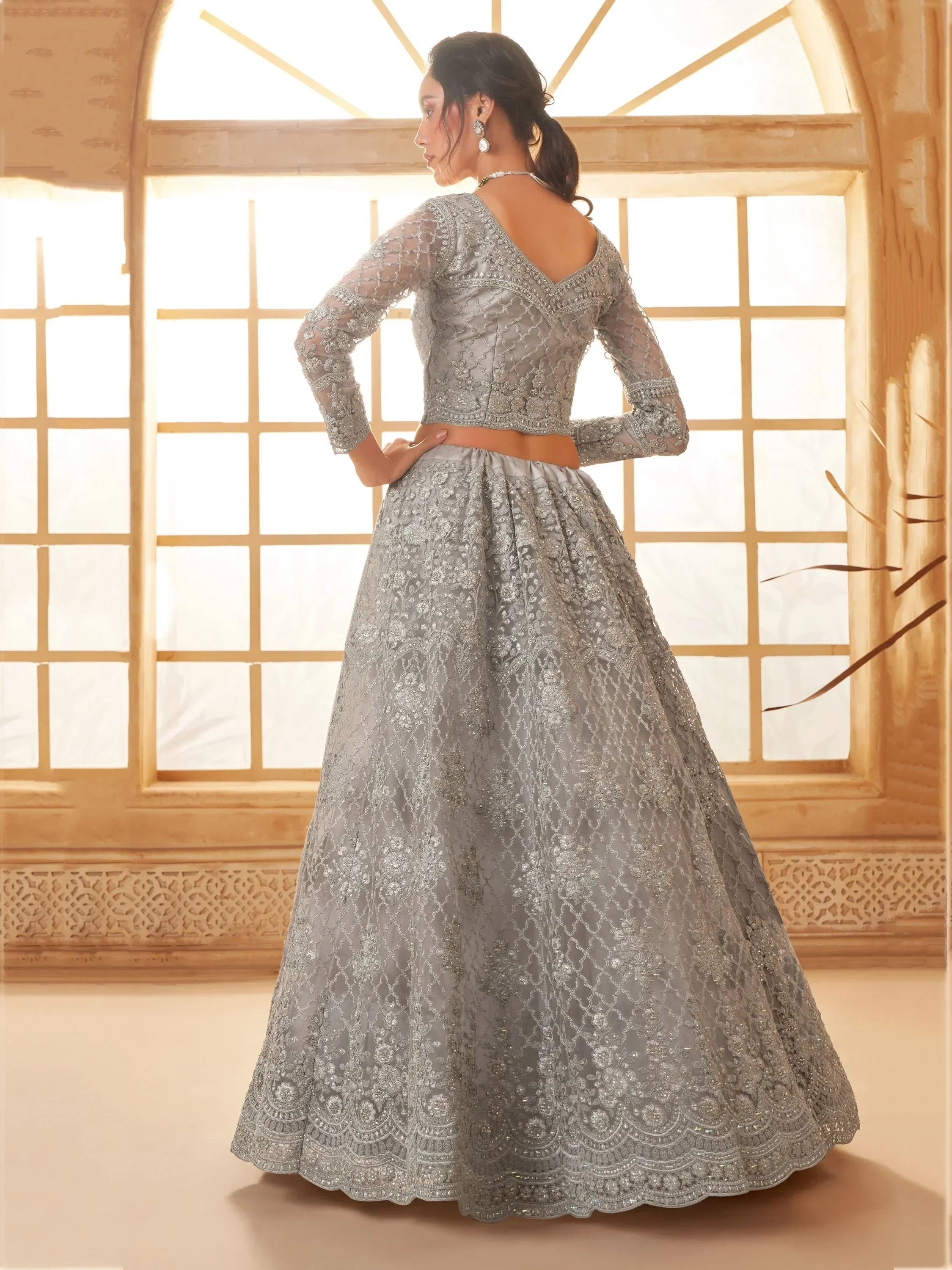 Elegant silver lehenga choli with intricate embroidery, perfect for Indian weddings and festive occasions.