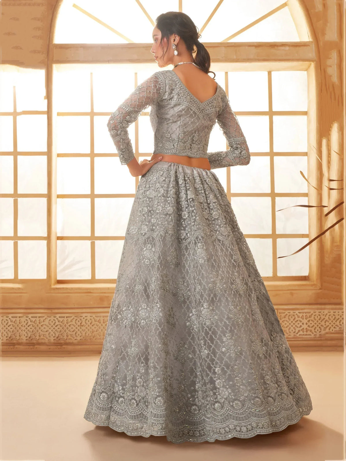 Elegant silver lehenga choli with intricate embroidery, perfect for Indian weddings and festive occasions.