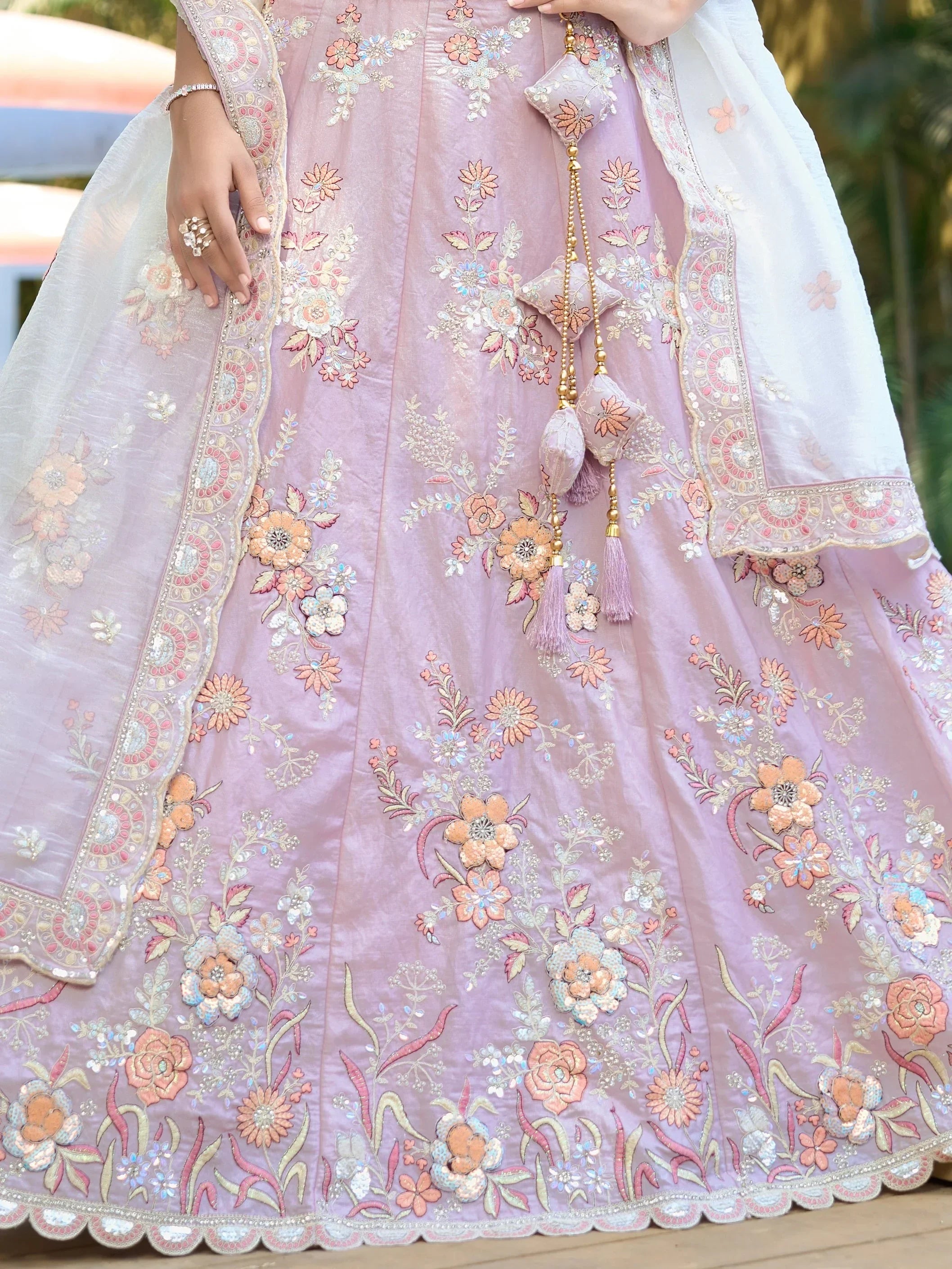 Pink floral embroidered lehenga choli with detailed appliqué and tassels, perfect for Indian ethnic wear