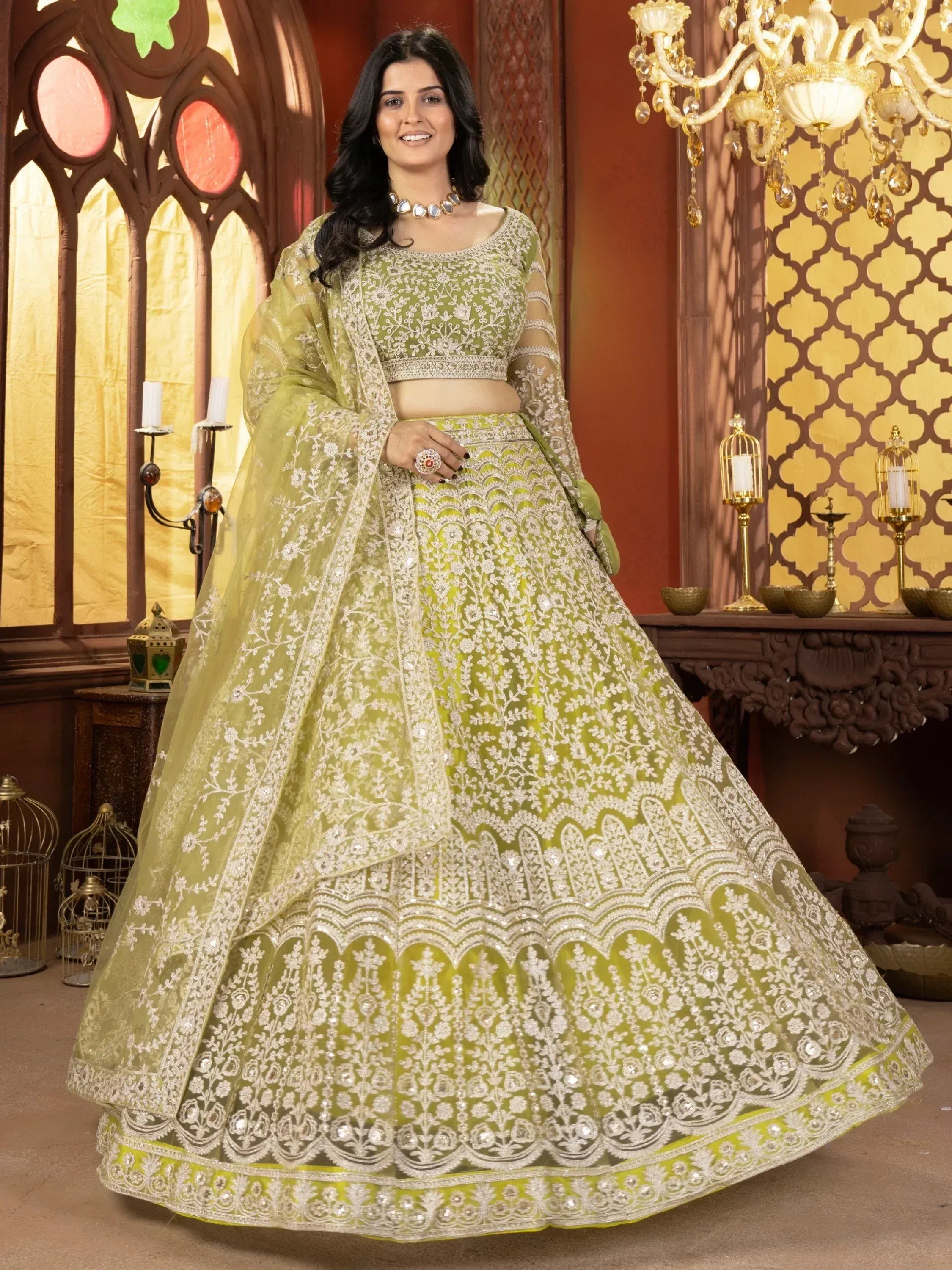 Elegant green designer lehenga choli with intricate white embroidery and sequins, perfect for weddings and festive occasions.